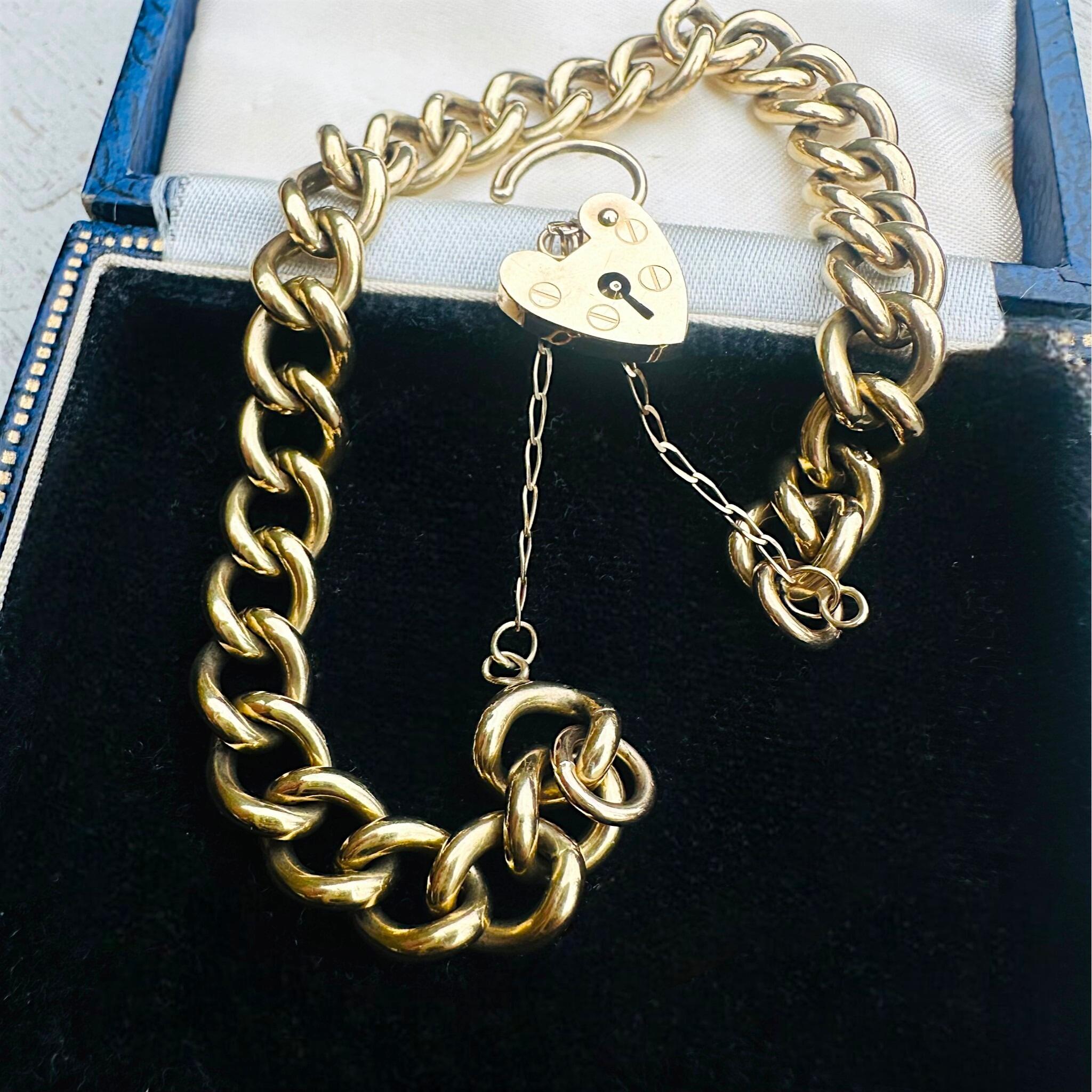 Heavy, Chunky Gold Curb Bracelet & Heart Padlock displayed on antique box