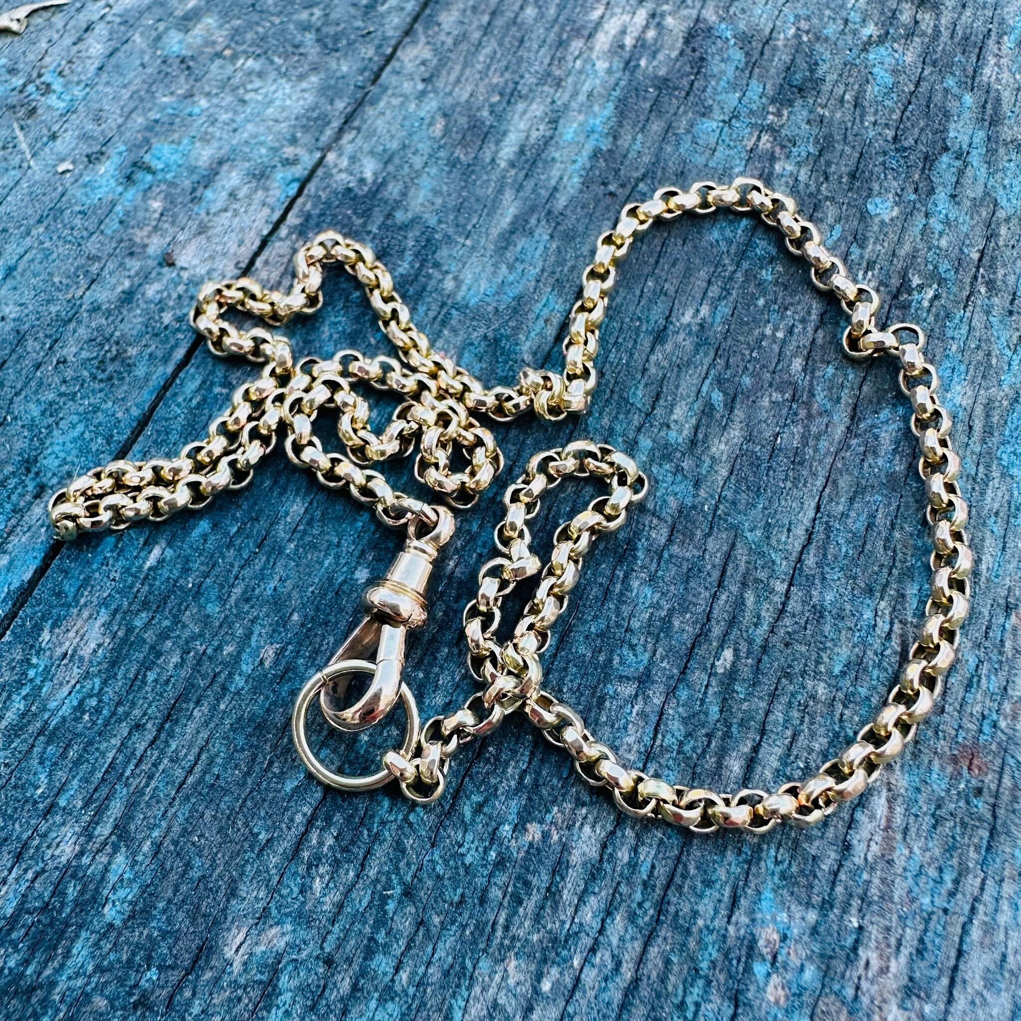 Antique Gold Belcher Link Chain Necklace & Dog Clip laying on a textured surface