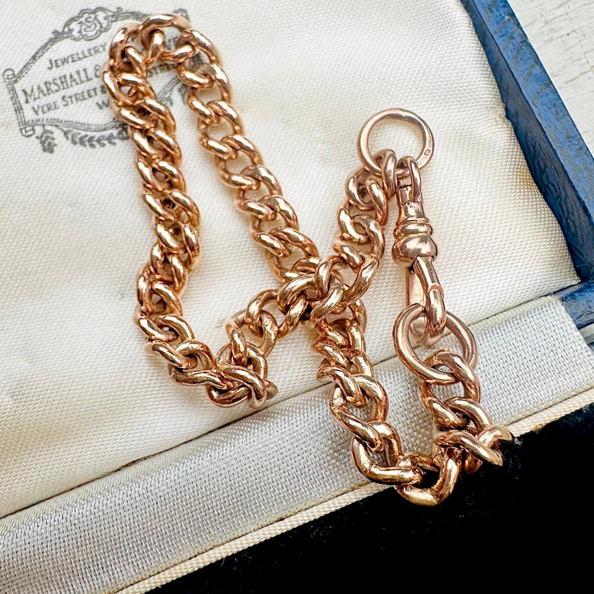 Antique Rose Gold Curb Link & Dog Clip Bracelet laying on antique box