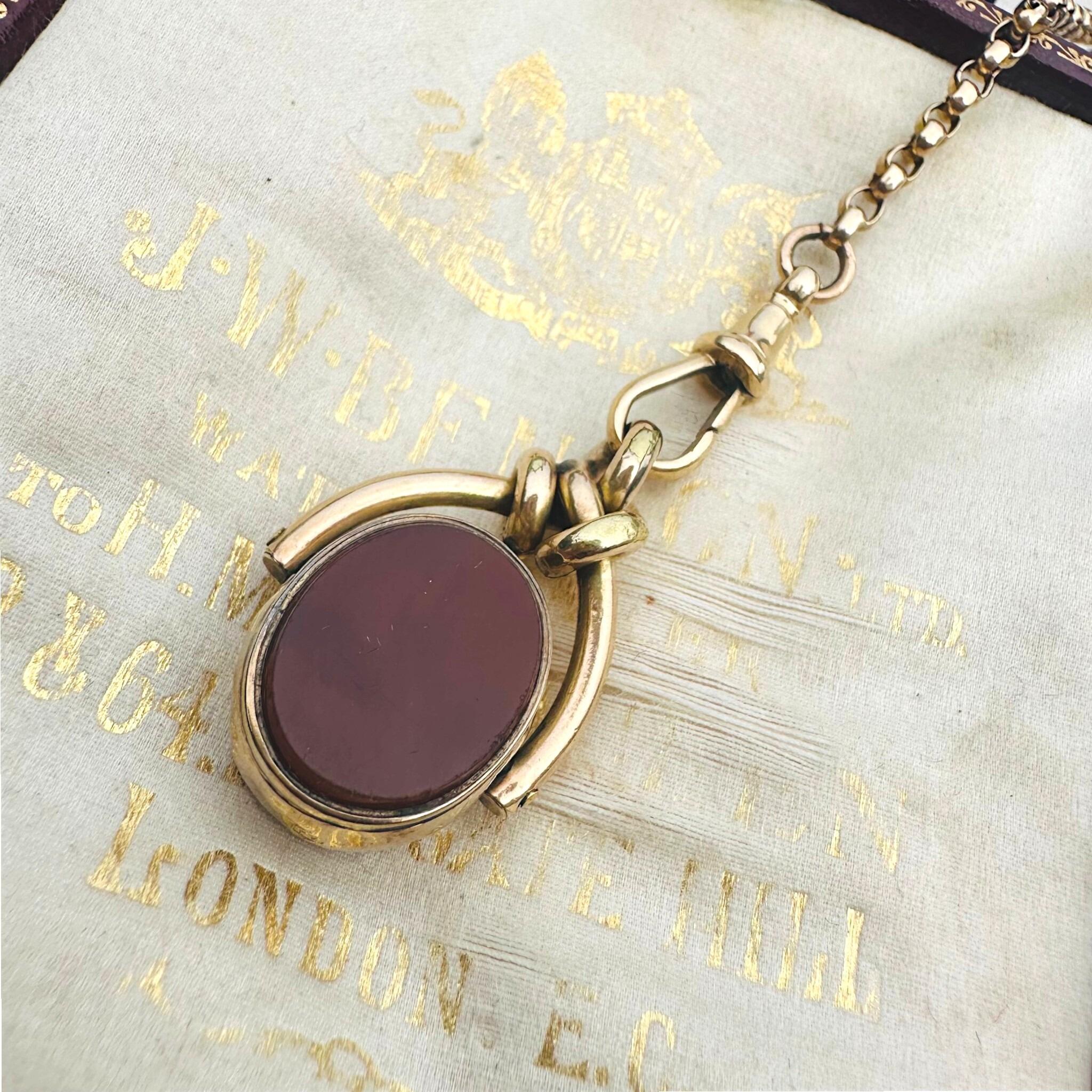 Antique Victorian 9ct Gold Bloodstone & Carnelian Swivel Fob displayed on antique box