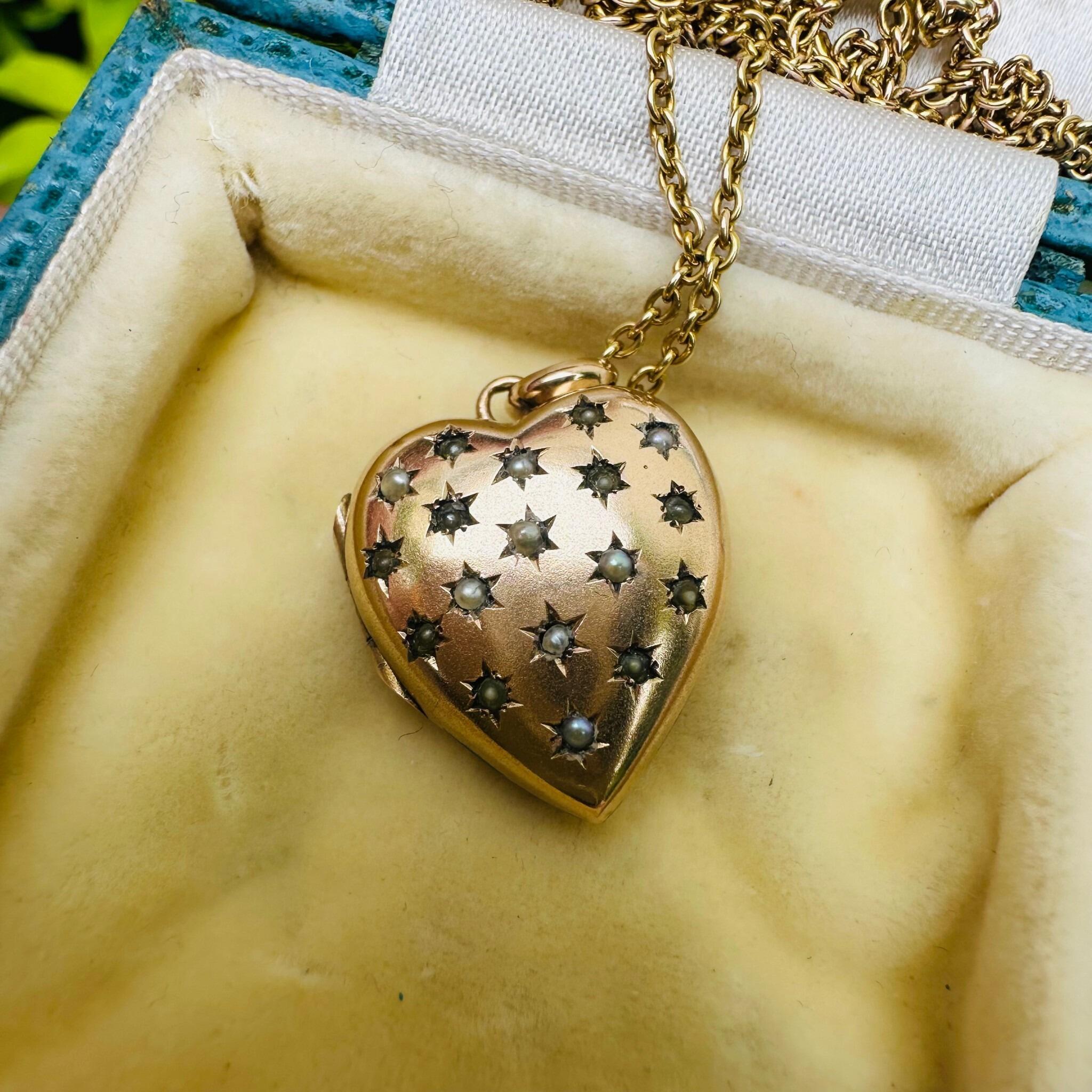 Vintage Gold Pearl Star Set Puffy Heart Locket displayed on antique box