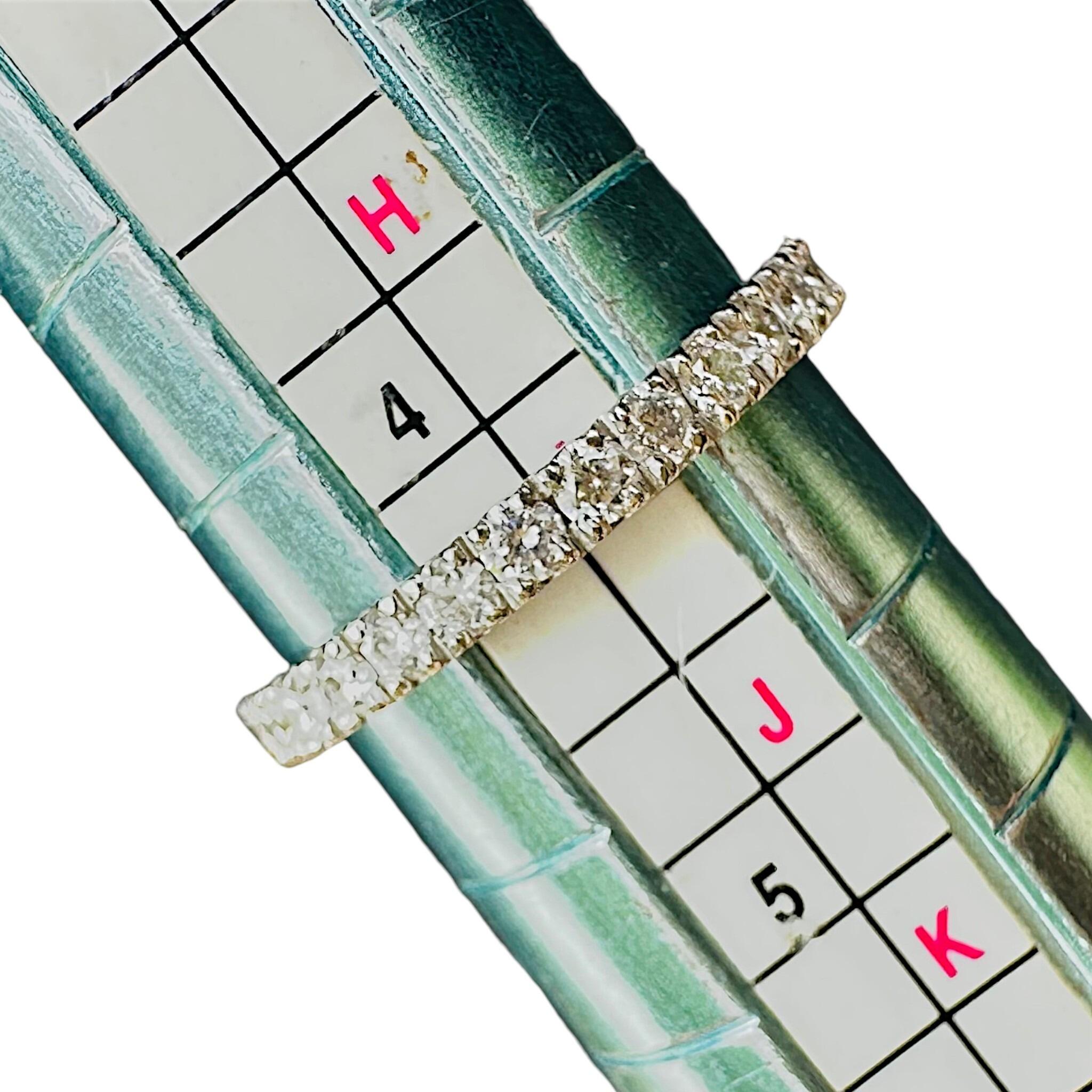 Vintage Platinum & Diamond Band Ring displayed on ring sizer with white background
