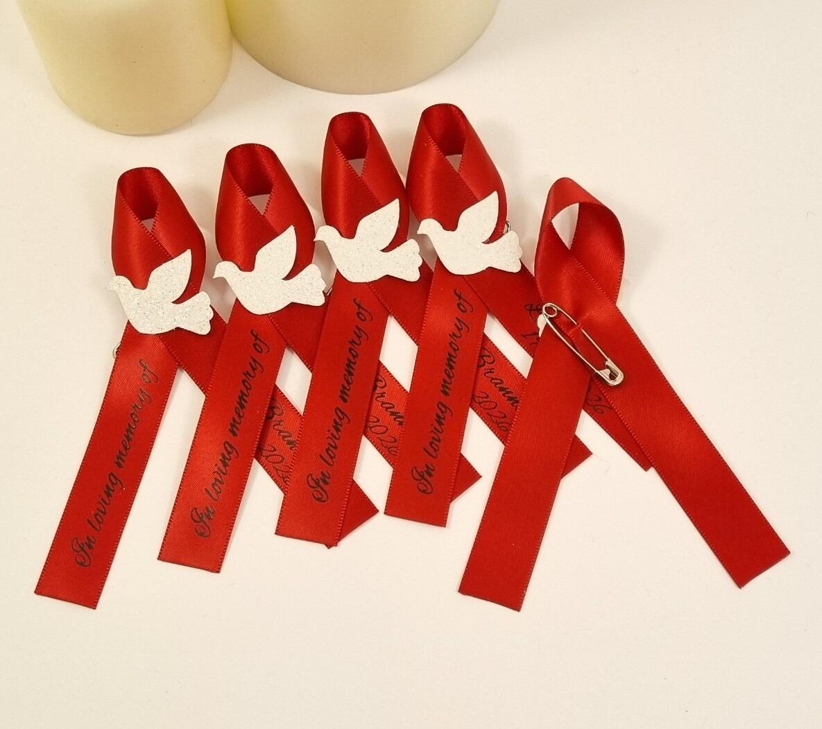 Red memorial ribbon with white dove