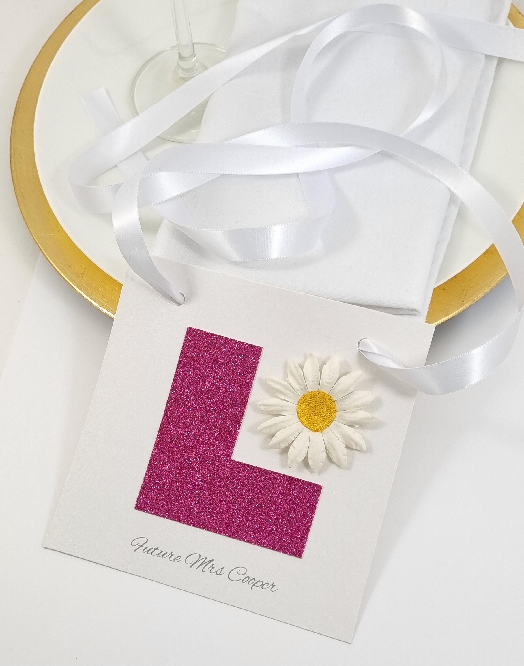 pink L plate and daisy