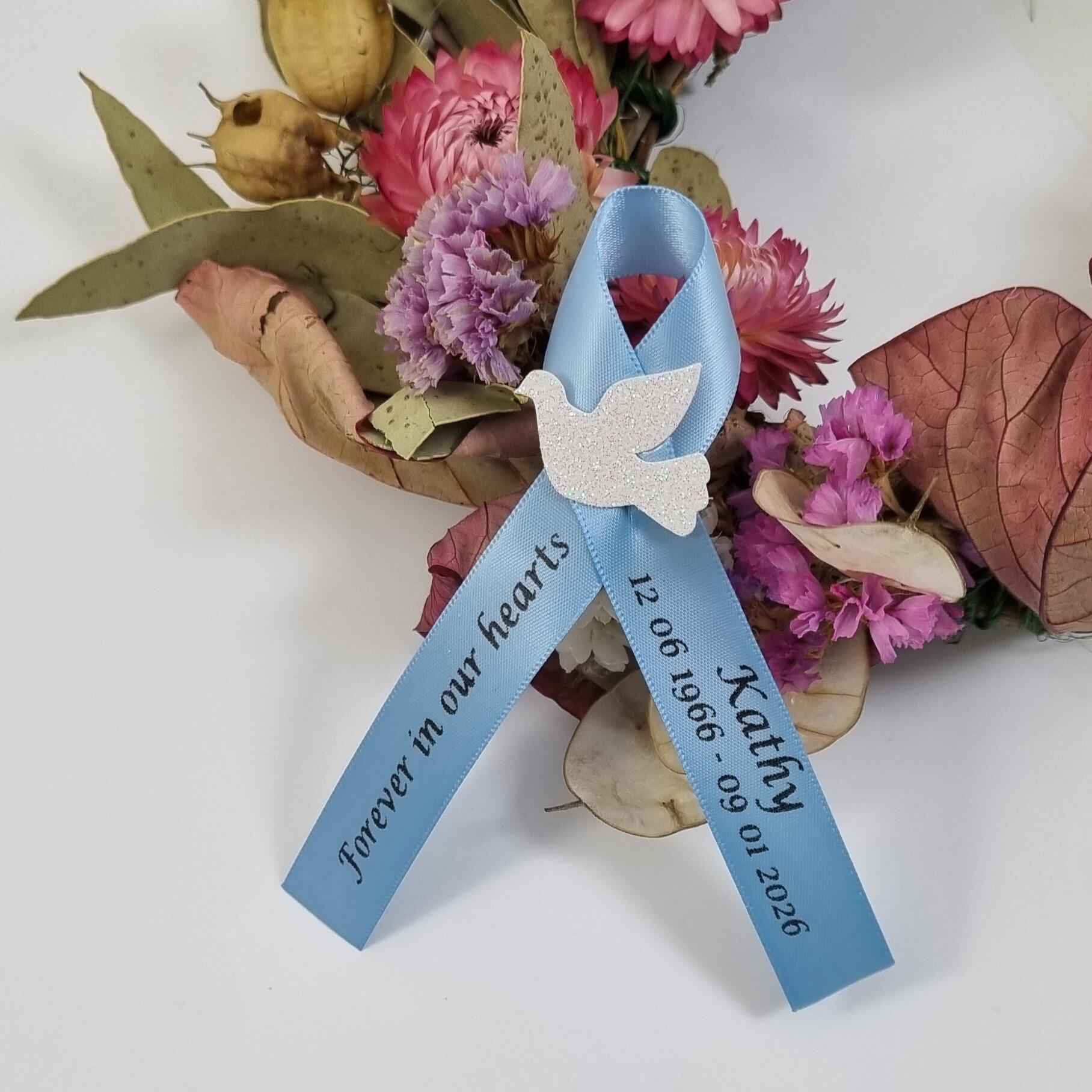 Funeral ribbon with white dove printed in black on baby blue ribbon