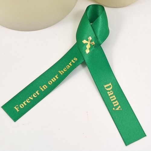 Gold cross on funeral favour ribbon
