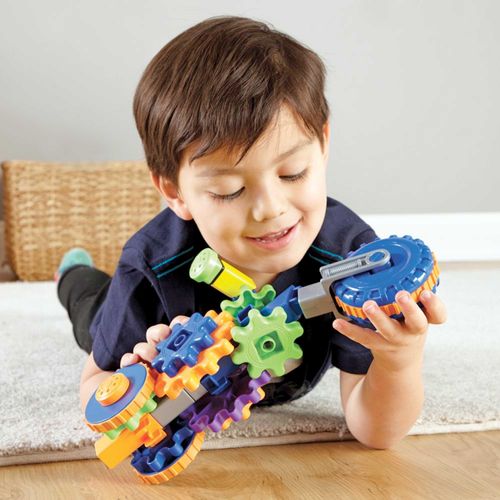 Child playing with gears construction toy