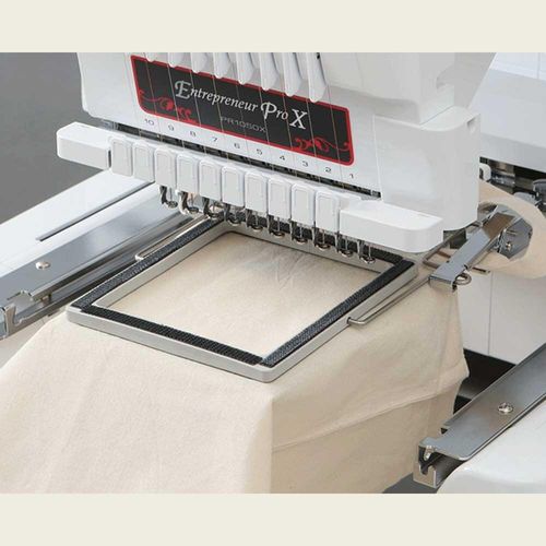 Clamp frame attached to the embroidery machine with fabric in the hoop