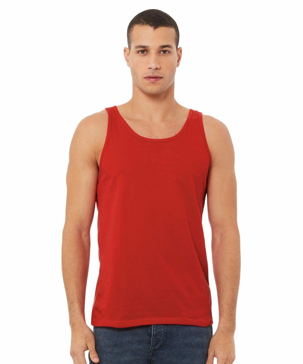 A man with short hair is standing and facing the camera. He is wearing a sleeveless, red Bella Canvas BE104 tank top and dark blue jeans. The background is plain white.