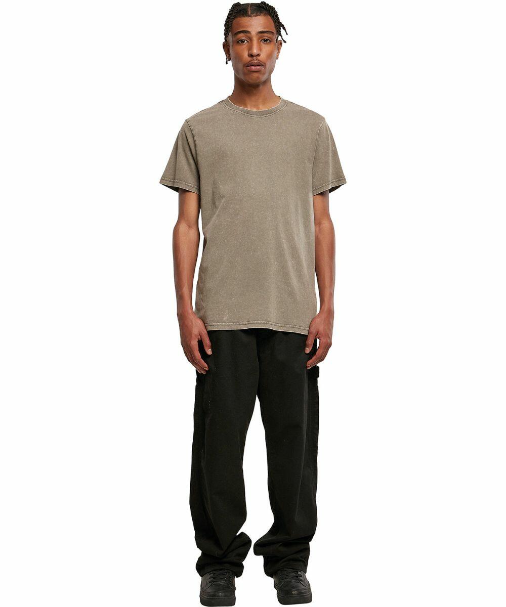 A person wearing a plain brown BY190 T-shirt by Build Your Brand, black cargo pants, and black shoes stands against a white background.