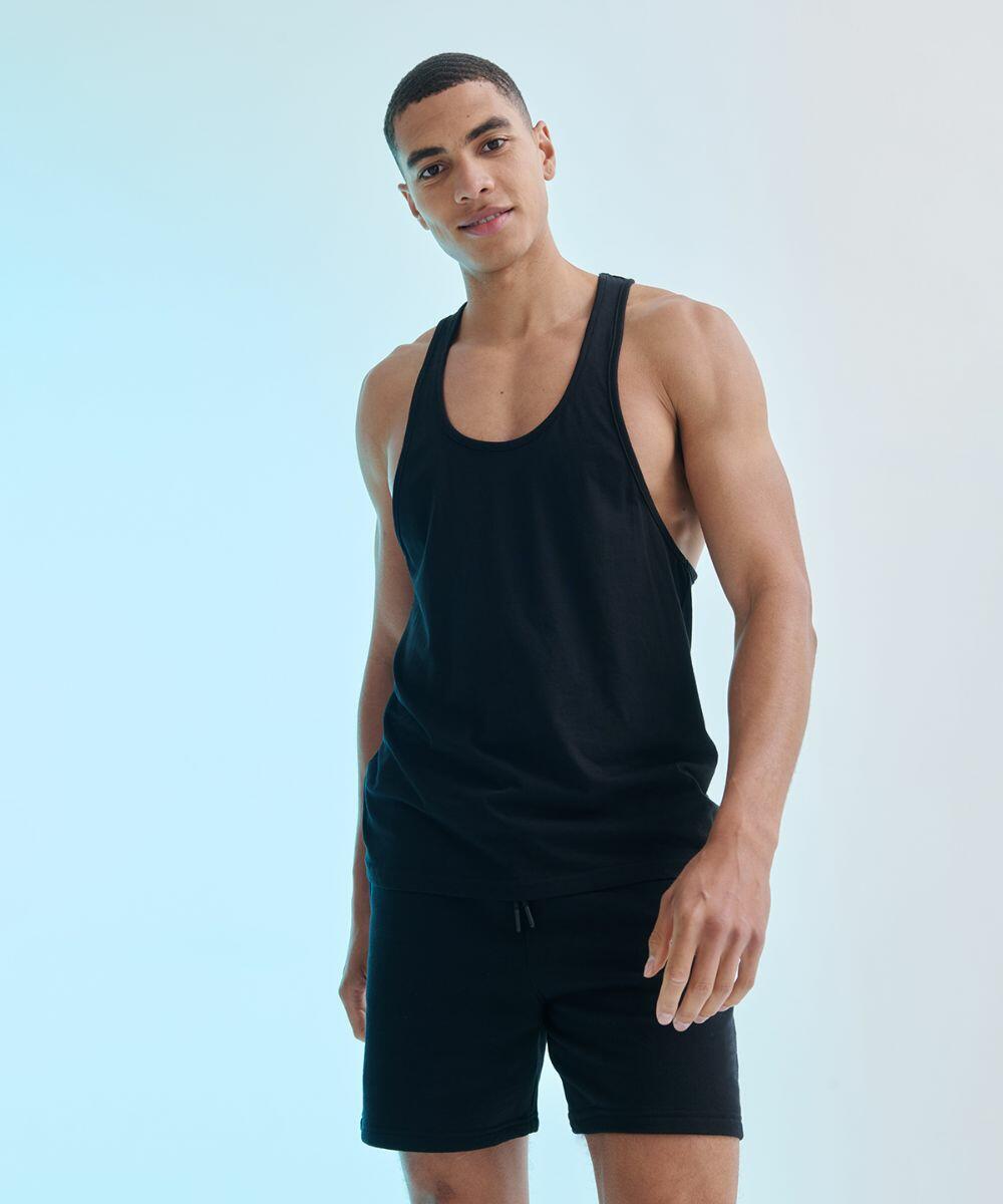 A man wearing a black SF SF236 tank top and black shorts stands against a gradient background of blue and white.