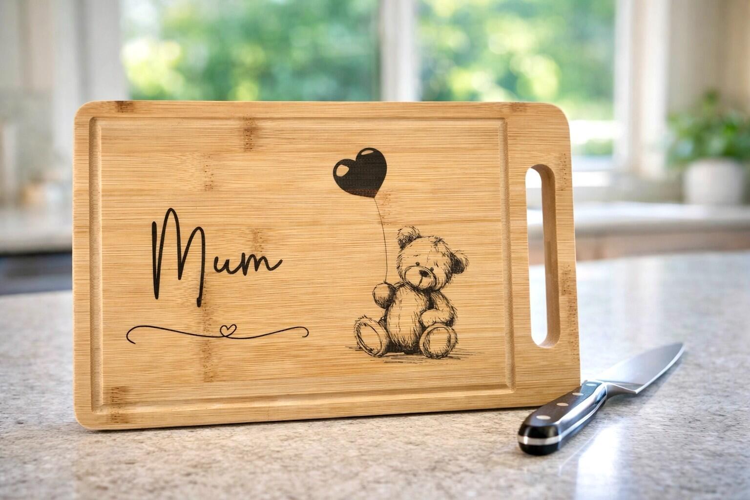 Bamboo chopping board with a laser etched design of a cute scruffy ted holding a balloon and a tasteful "Mum" design