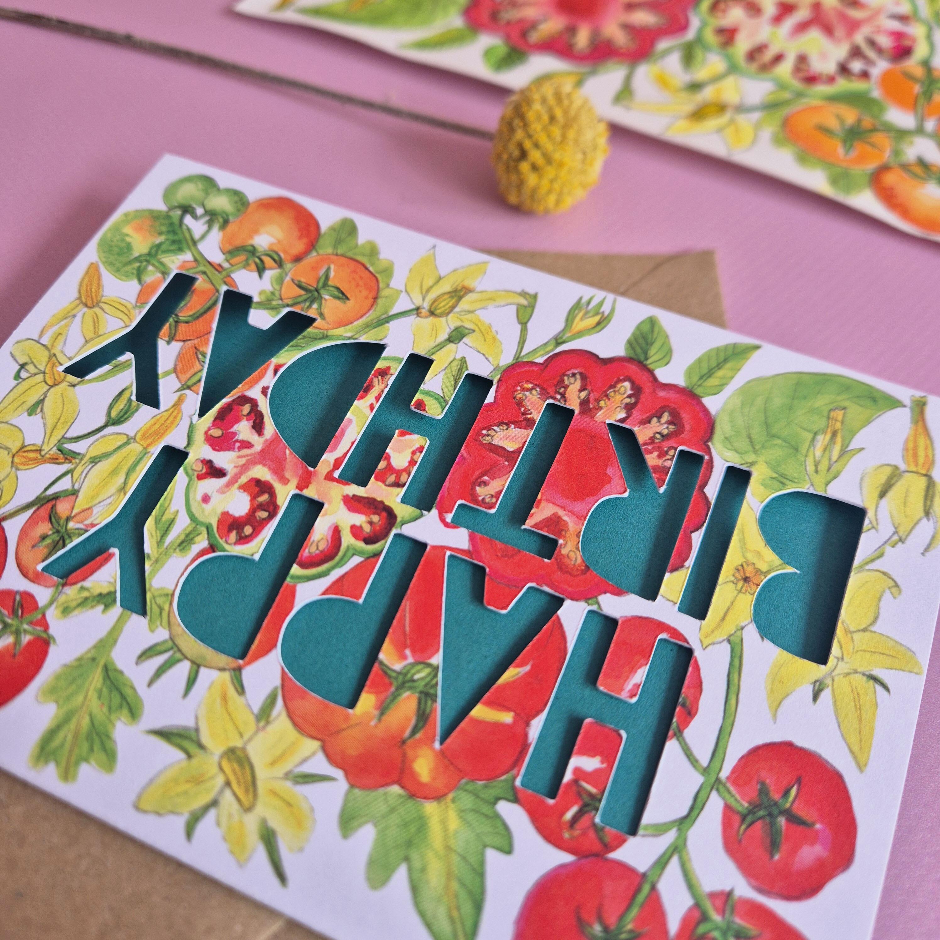 Birthday card with tomato print and paper cut text that says Happy Birthday in green backshot
