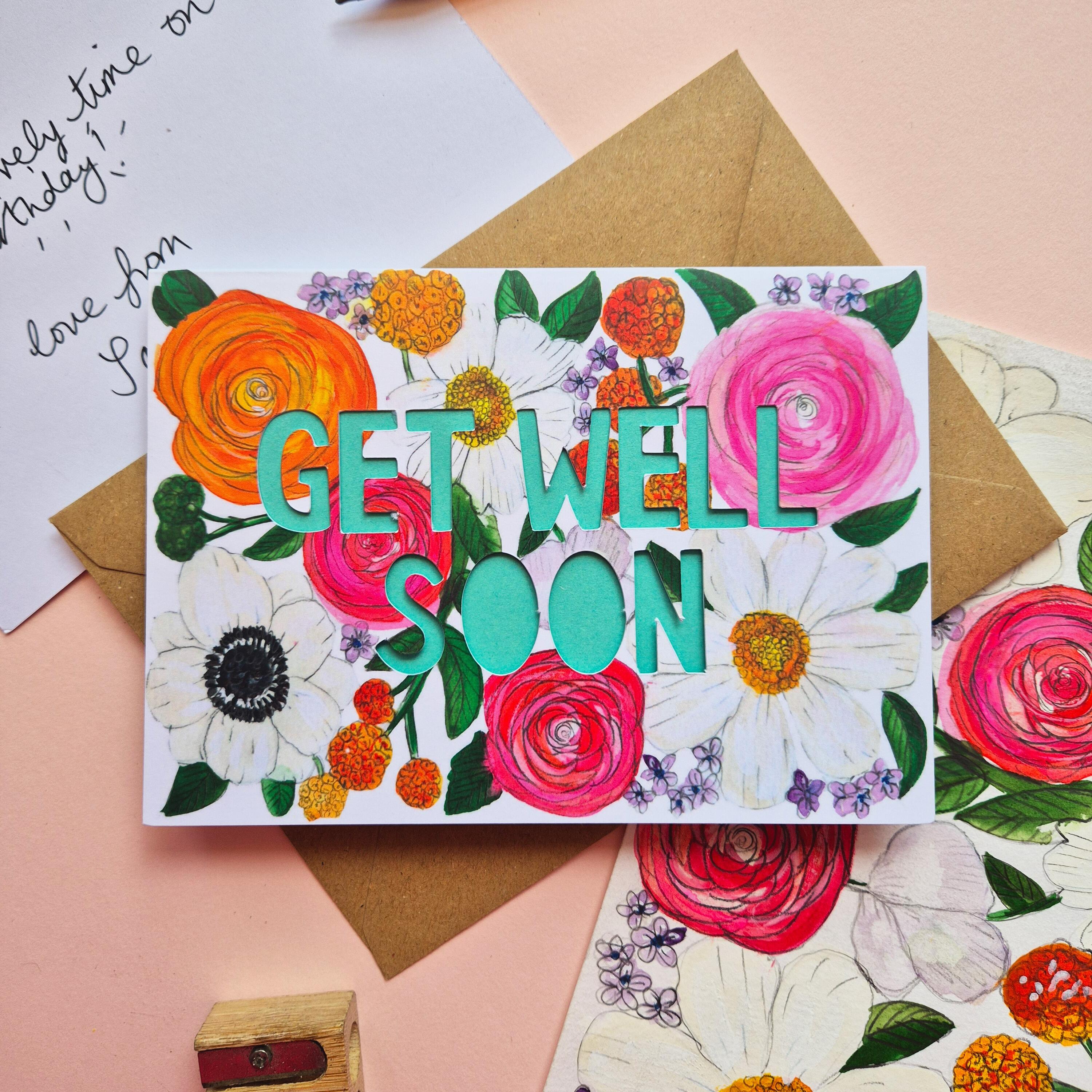 Get Well Soon card with bright floral illustration and paper cut text with bright turquoise backing paper