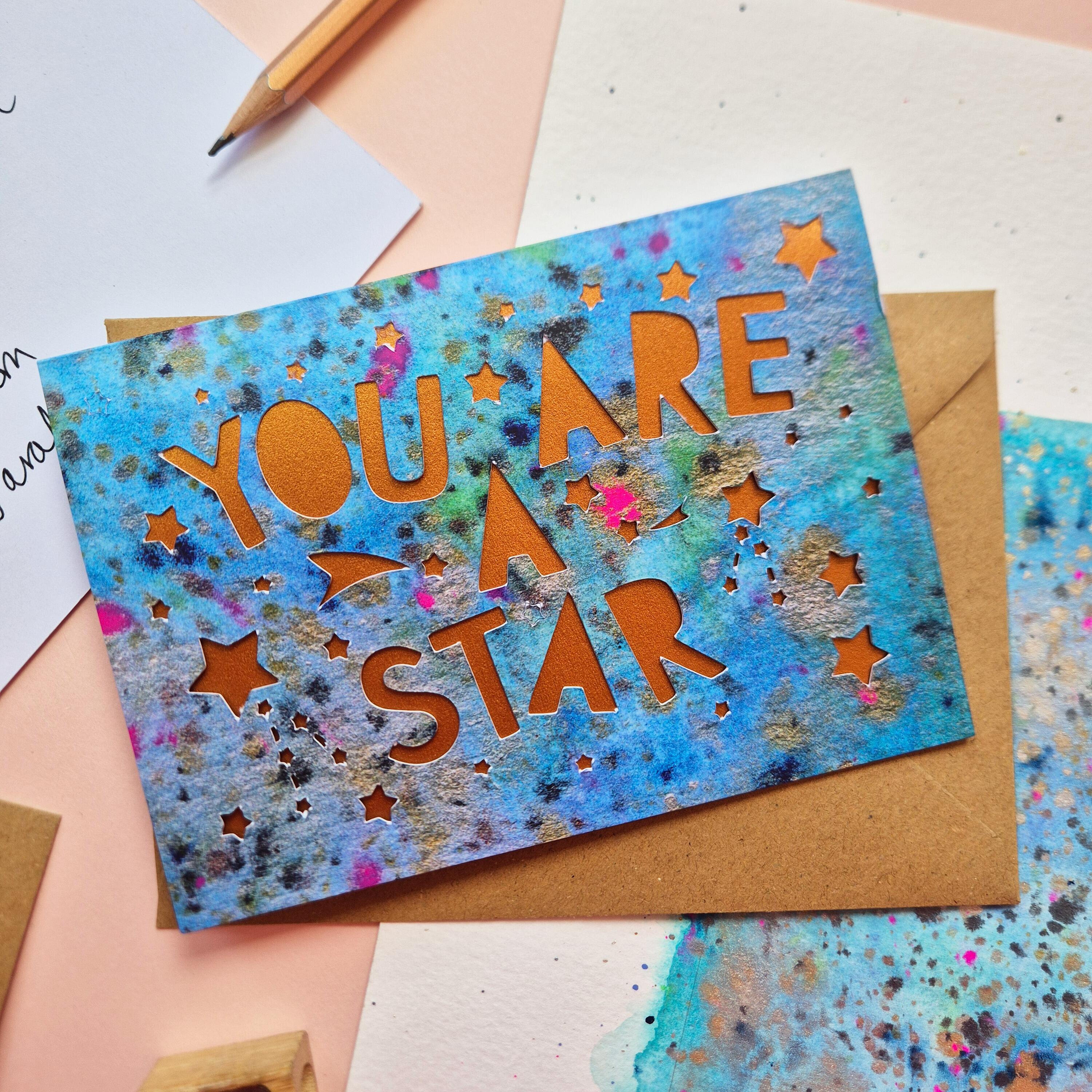 Celestial Thank You card with die cut 'You are a star' text and stars, backed with a shimmering bronze liner
