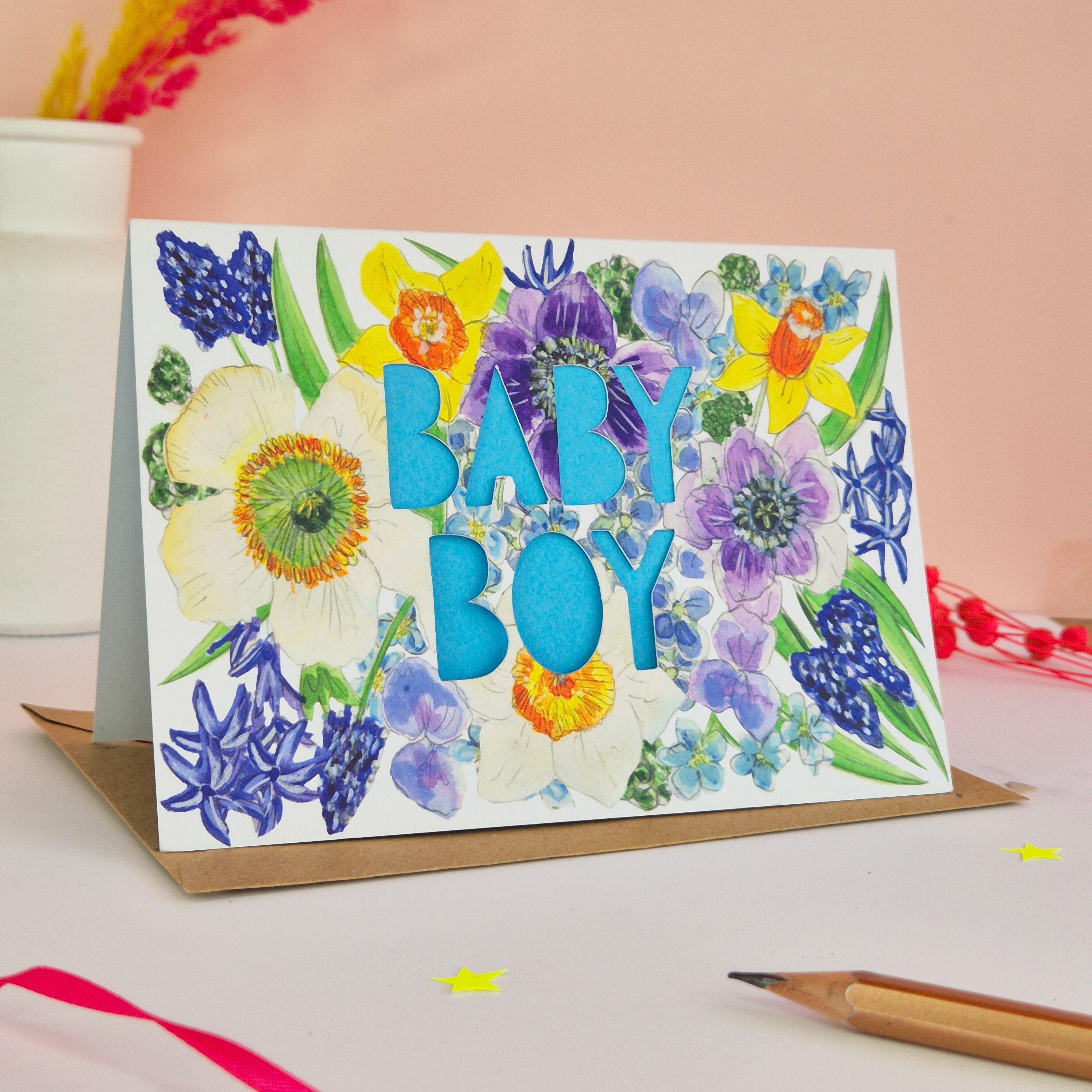 Floral Illustration card with die cut Baby Boy text and bright blue paper liner