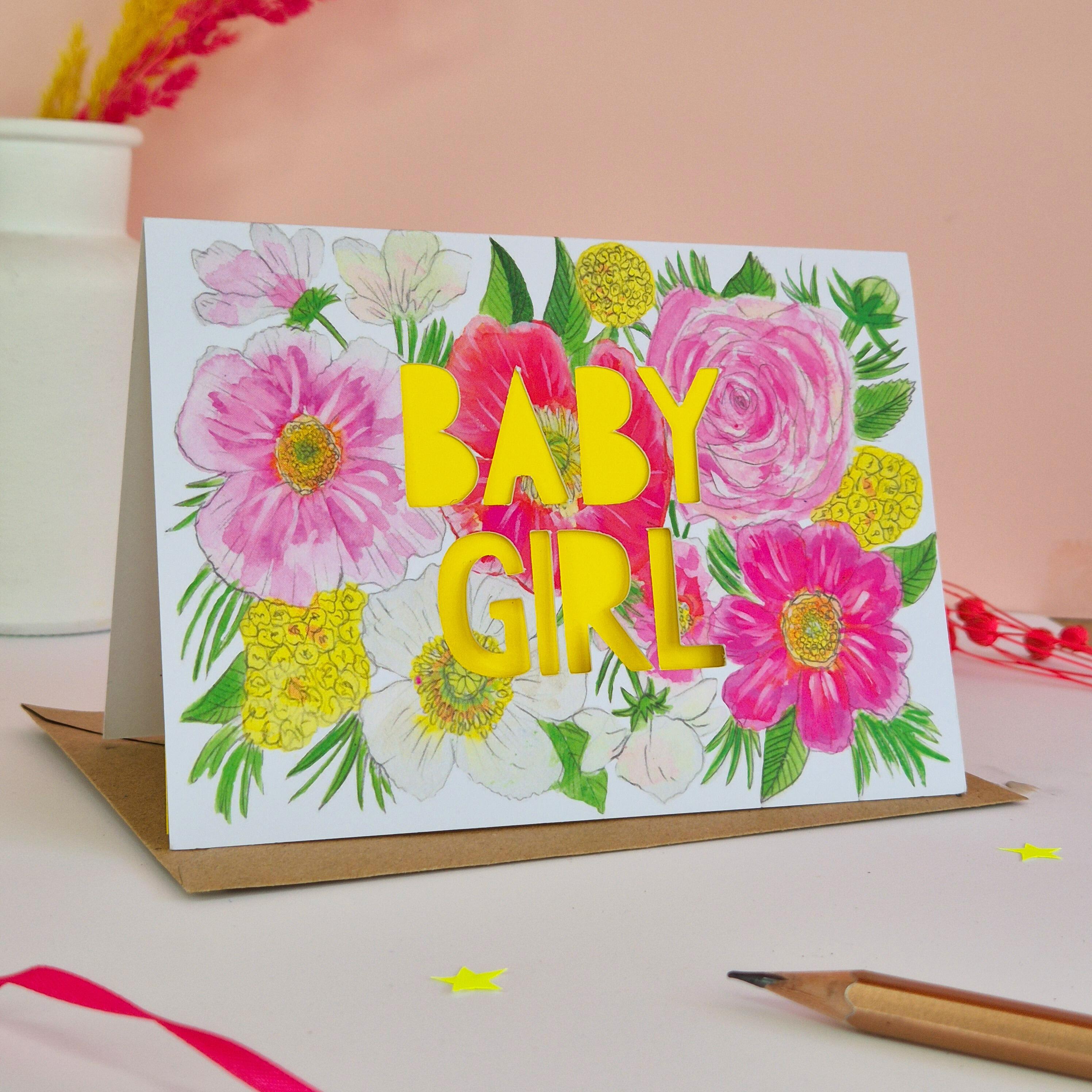 Pink and yellow floral illustration card with baby girl die cut text and bright yellow paper liner