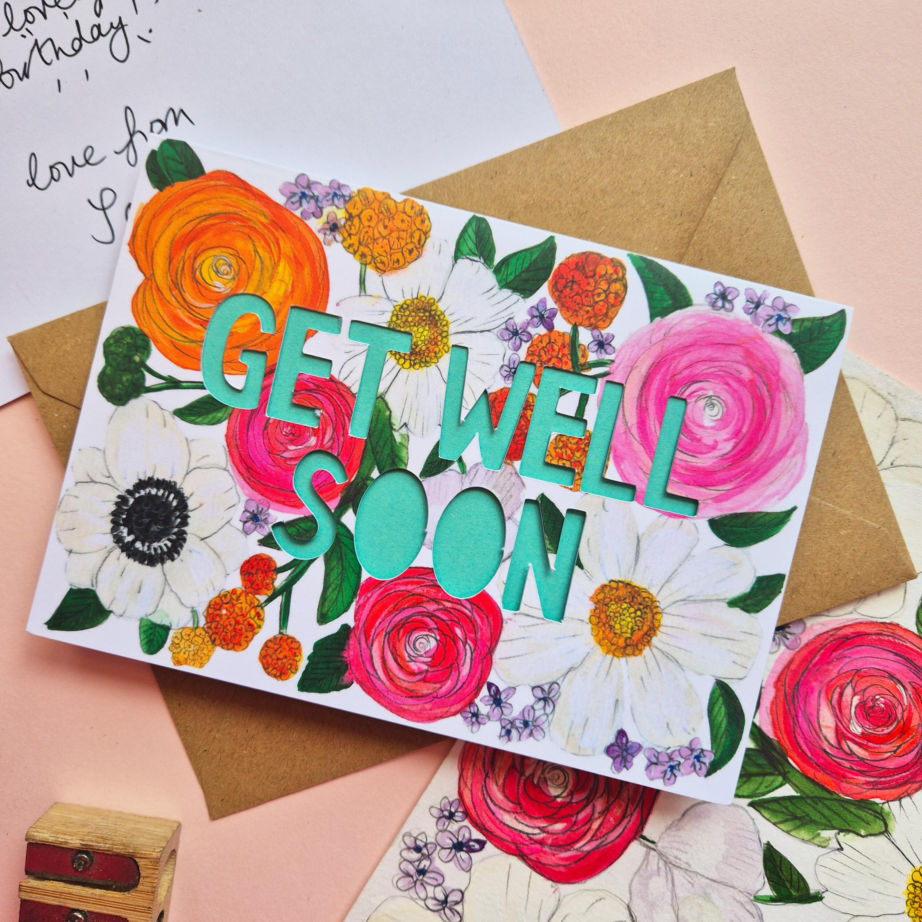 Get Well Soon card with bright floral illustration and paper cut text with bright turquoise backing paper
