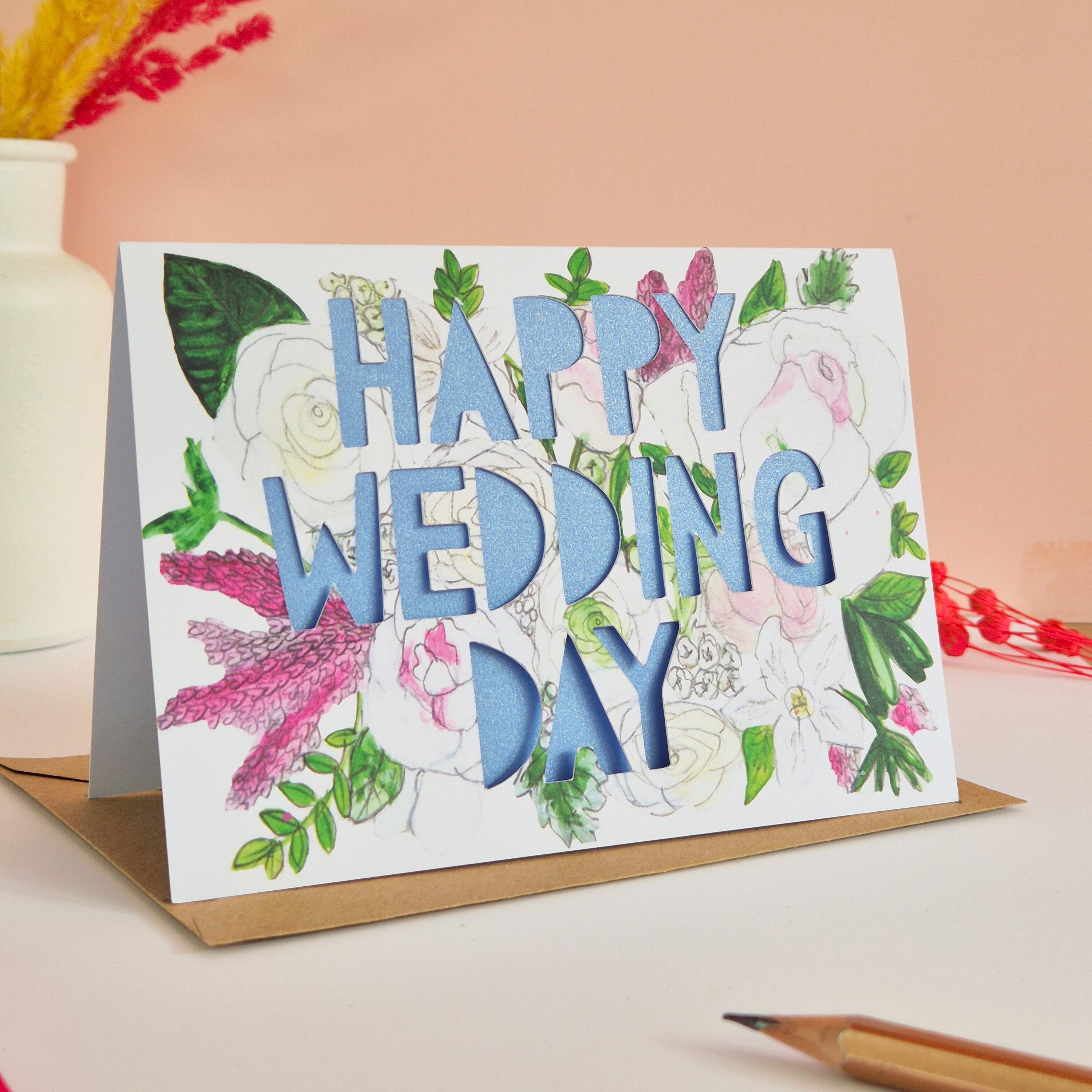 White and Pink floral illustration card with Happy Wedding Day paper cut text and shimmering blue paper liner