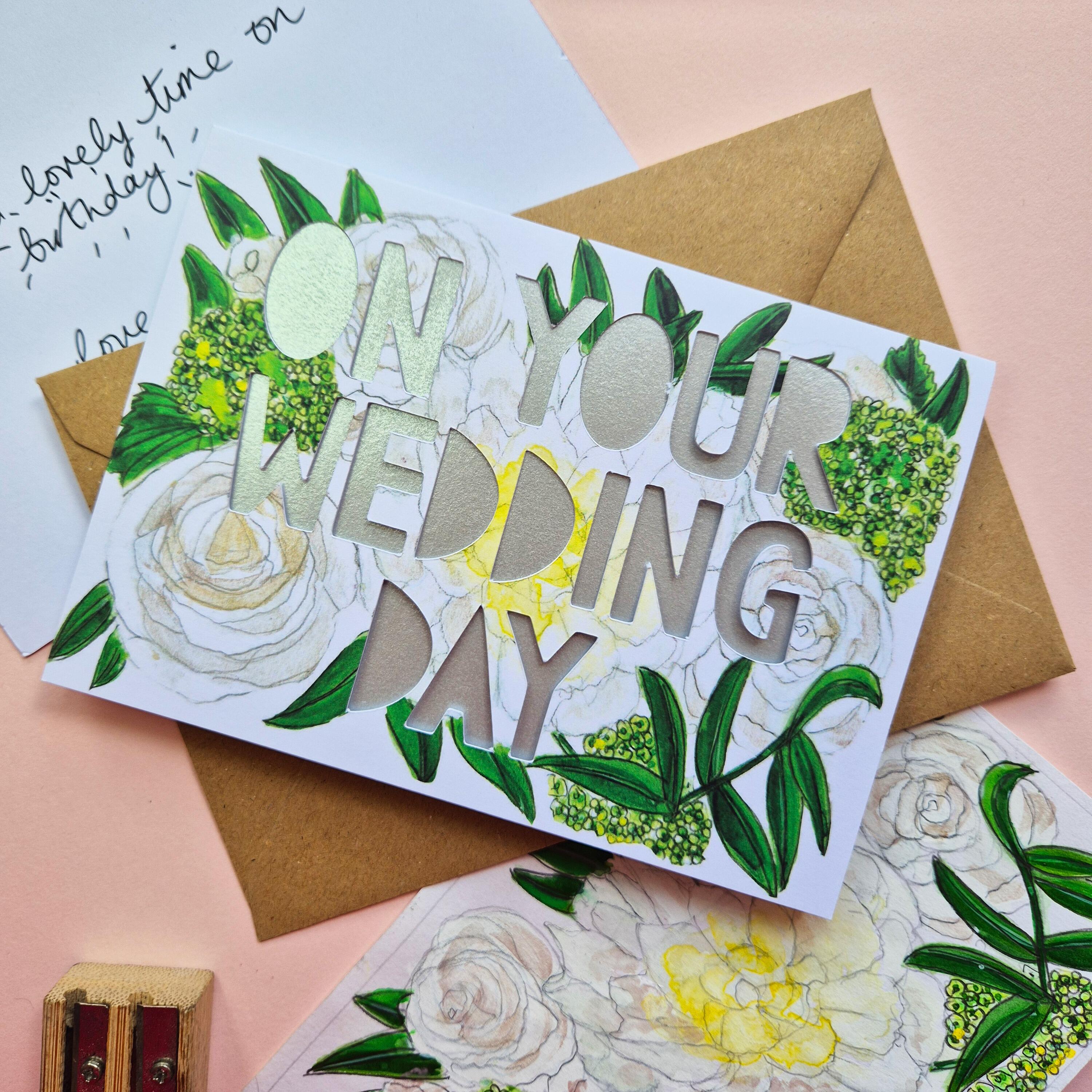 White and green floral illustration card with On Your Wedding Day die cut text and shimmering silver backing paper liner