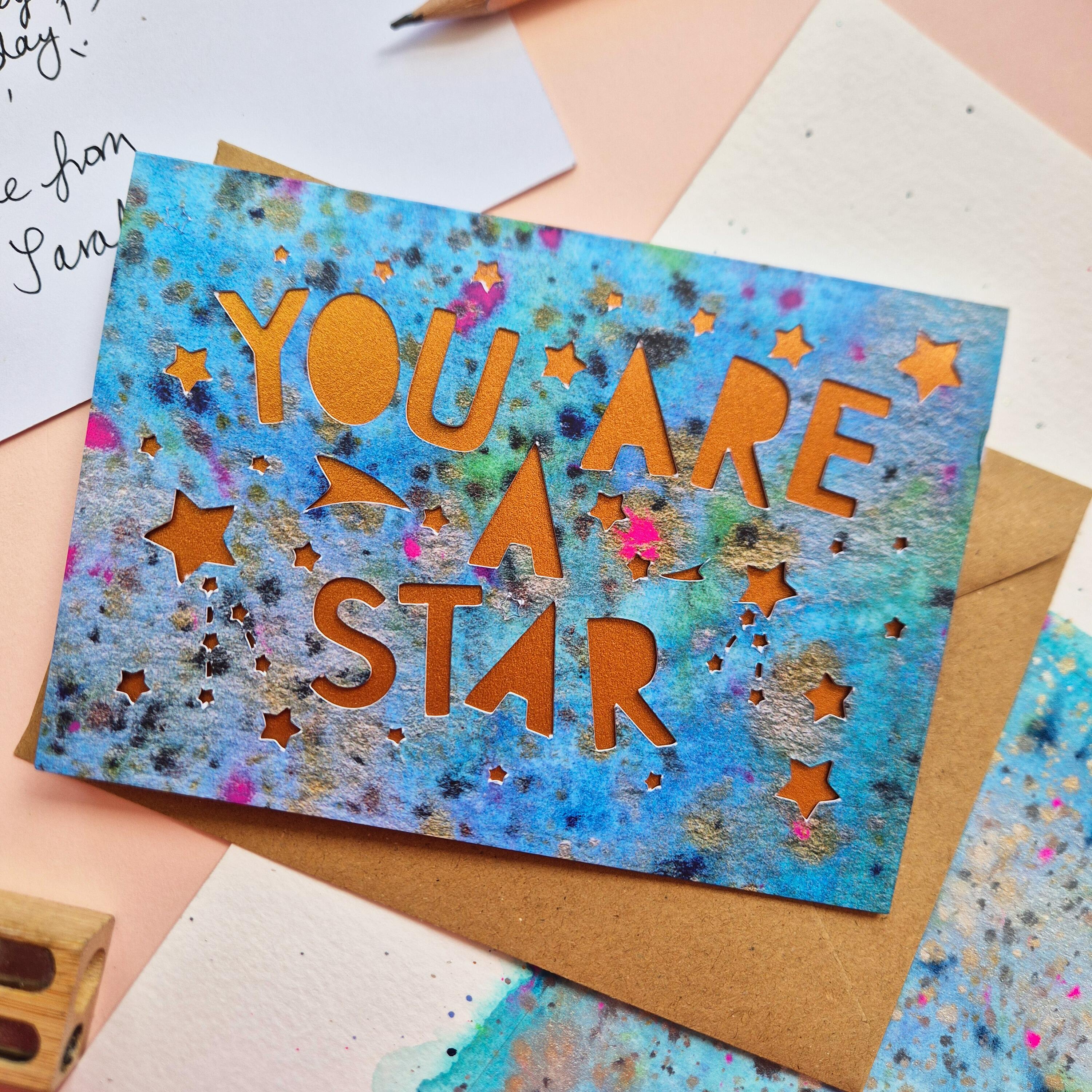 Celestial Thank You card with die cut 'You are a star' text and stars, backed with a shimmering bronze liner