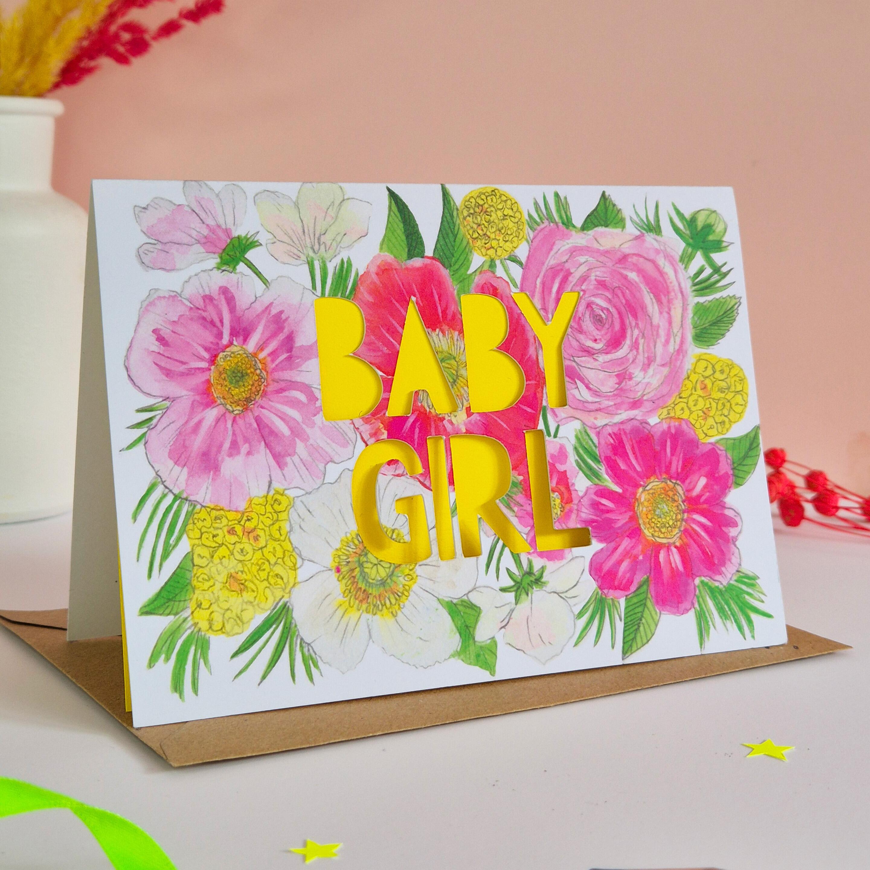 Pink and yellow floral illustration card with baby girl die cut text and bright yellow paper liner