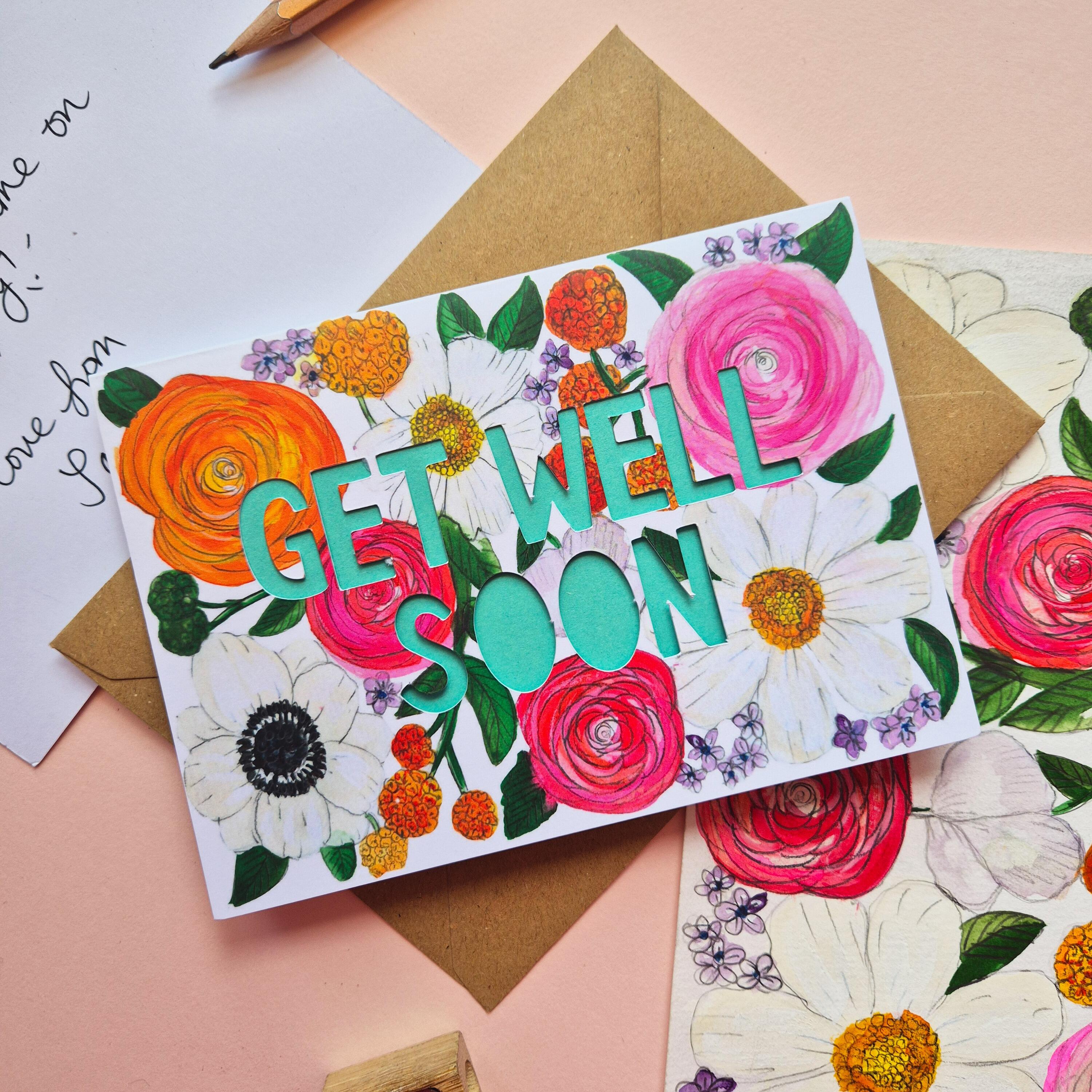 Get Well Soon card with bright floral illustration and paper cut text with bright turquoise backing paper