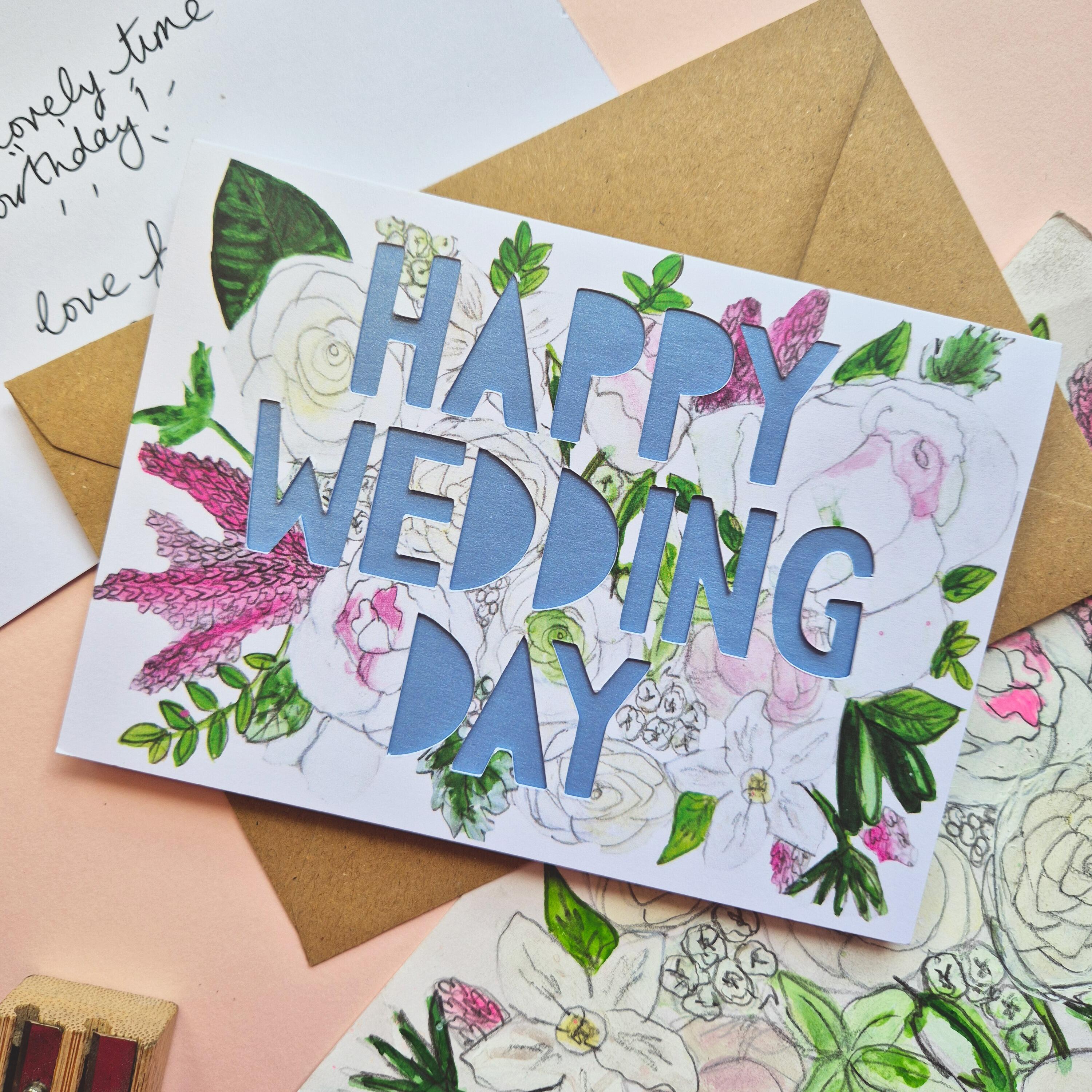 White and Pink floral illustration card with Happy Wedding Day paper cut text and shimmering blue paper liner