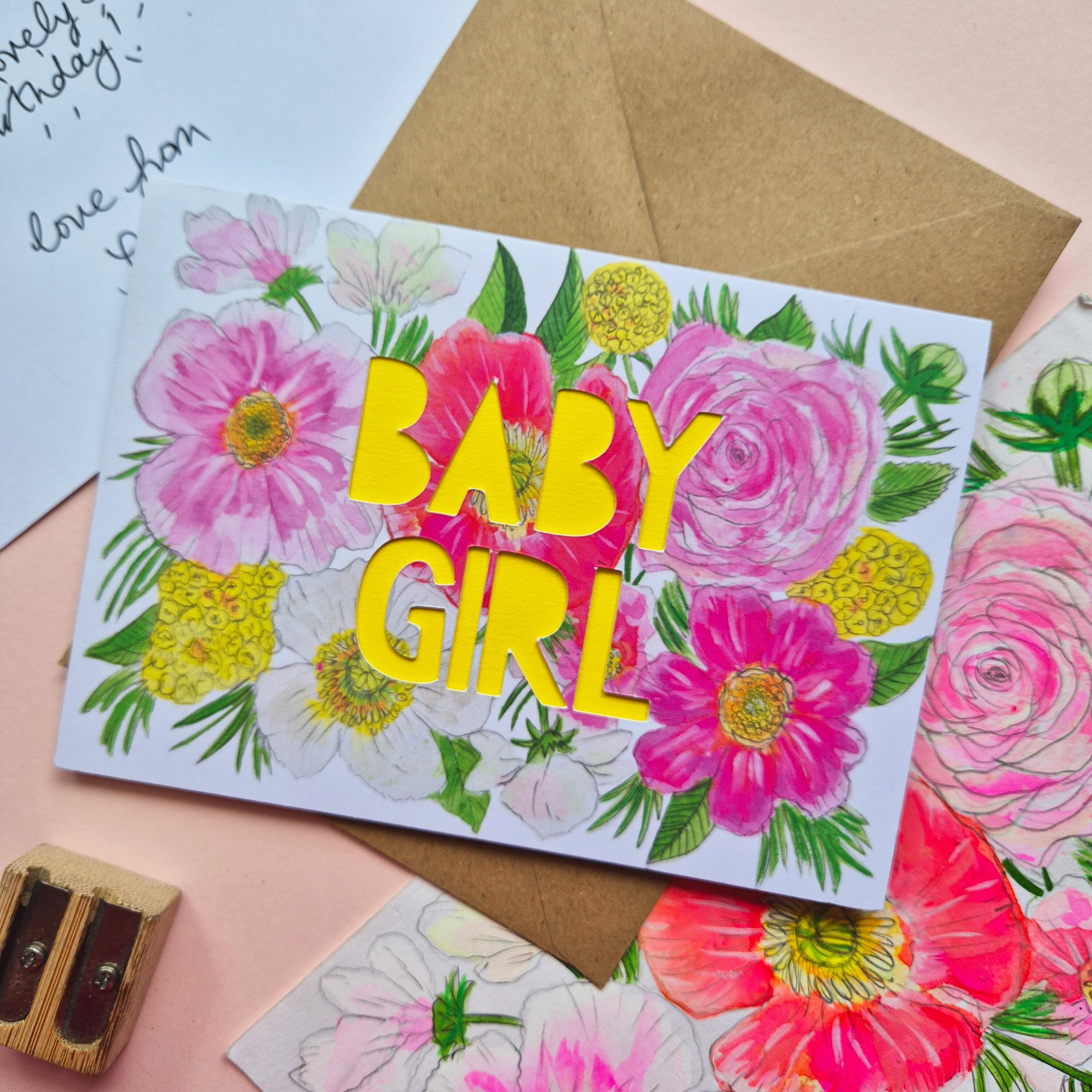 Pink and yellow floral illustration card with baby girl die cut text and bright yellow paper liner