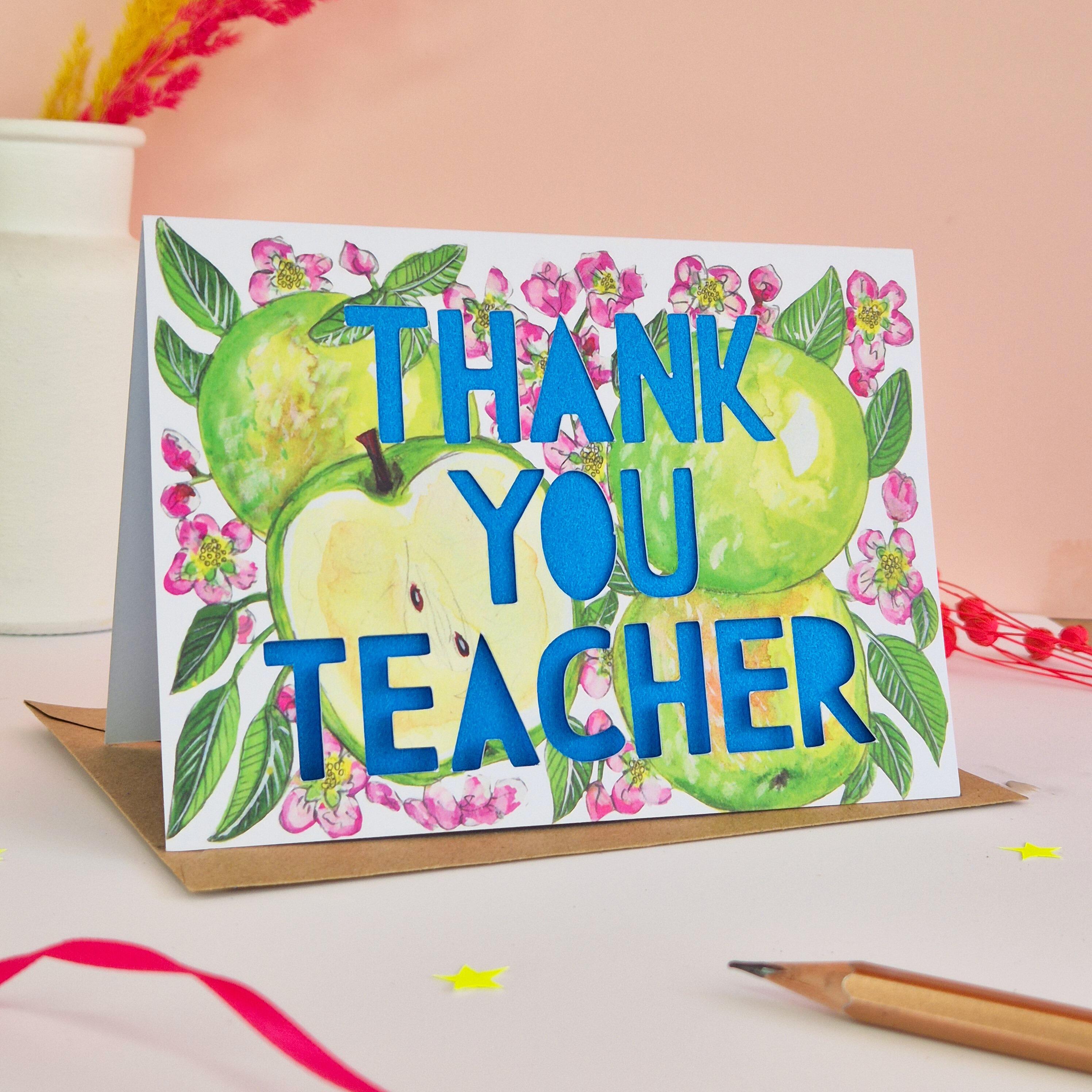 Floral and apple illustration with Thank You teacher paper cut text and bright blue backing paper