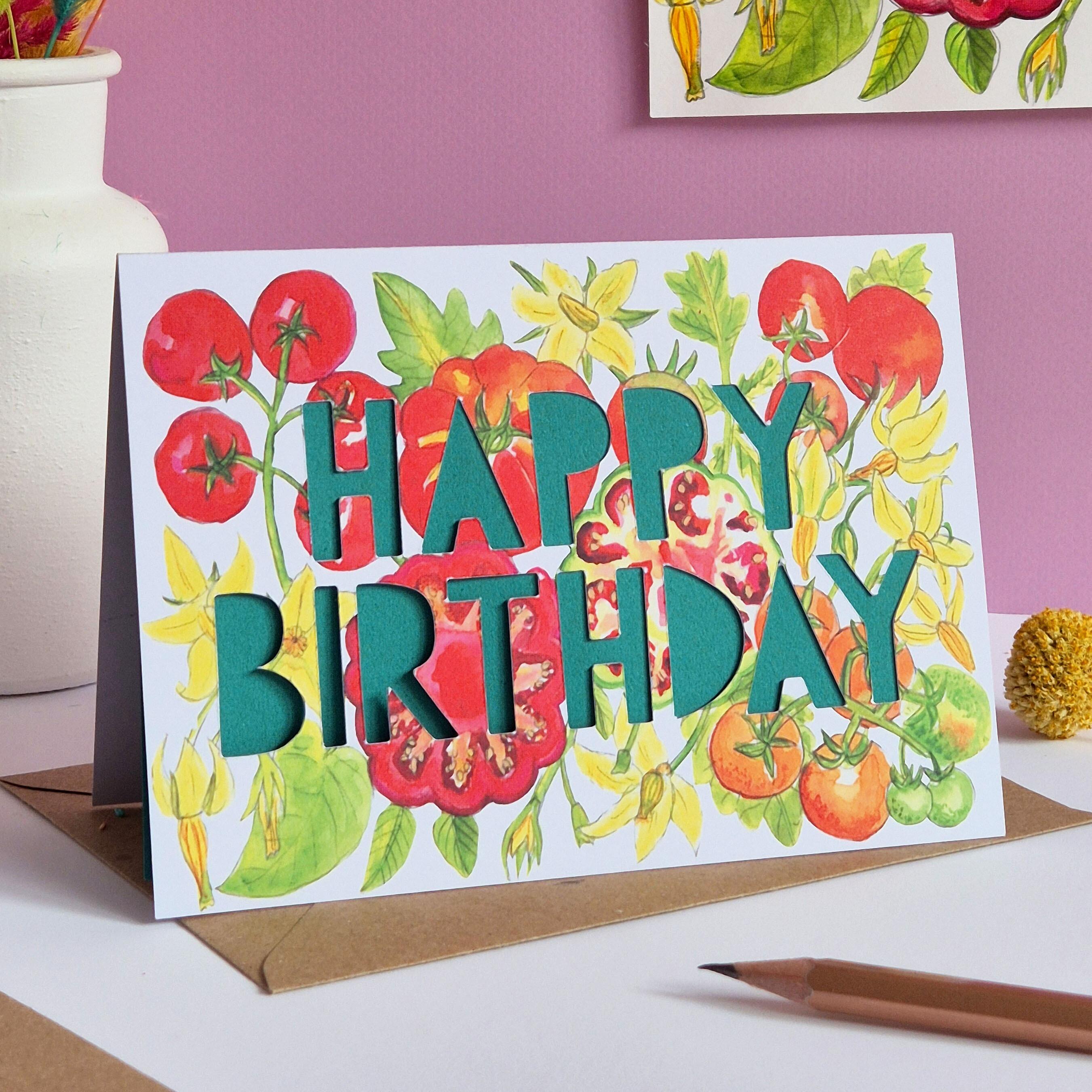 Birthday card with tomato print and paper cut text that says Happy Birthday in green
