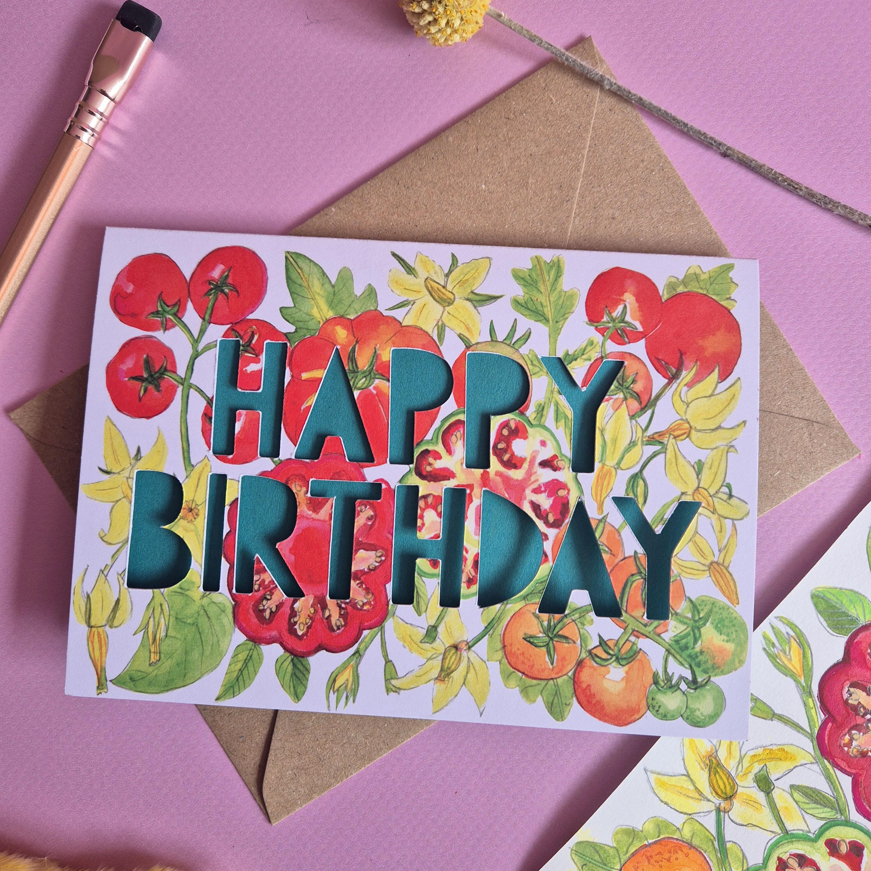 Birthday card with tomato print and paper cut text that says Happy Birthday in green close up