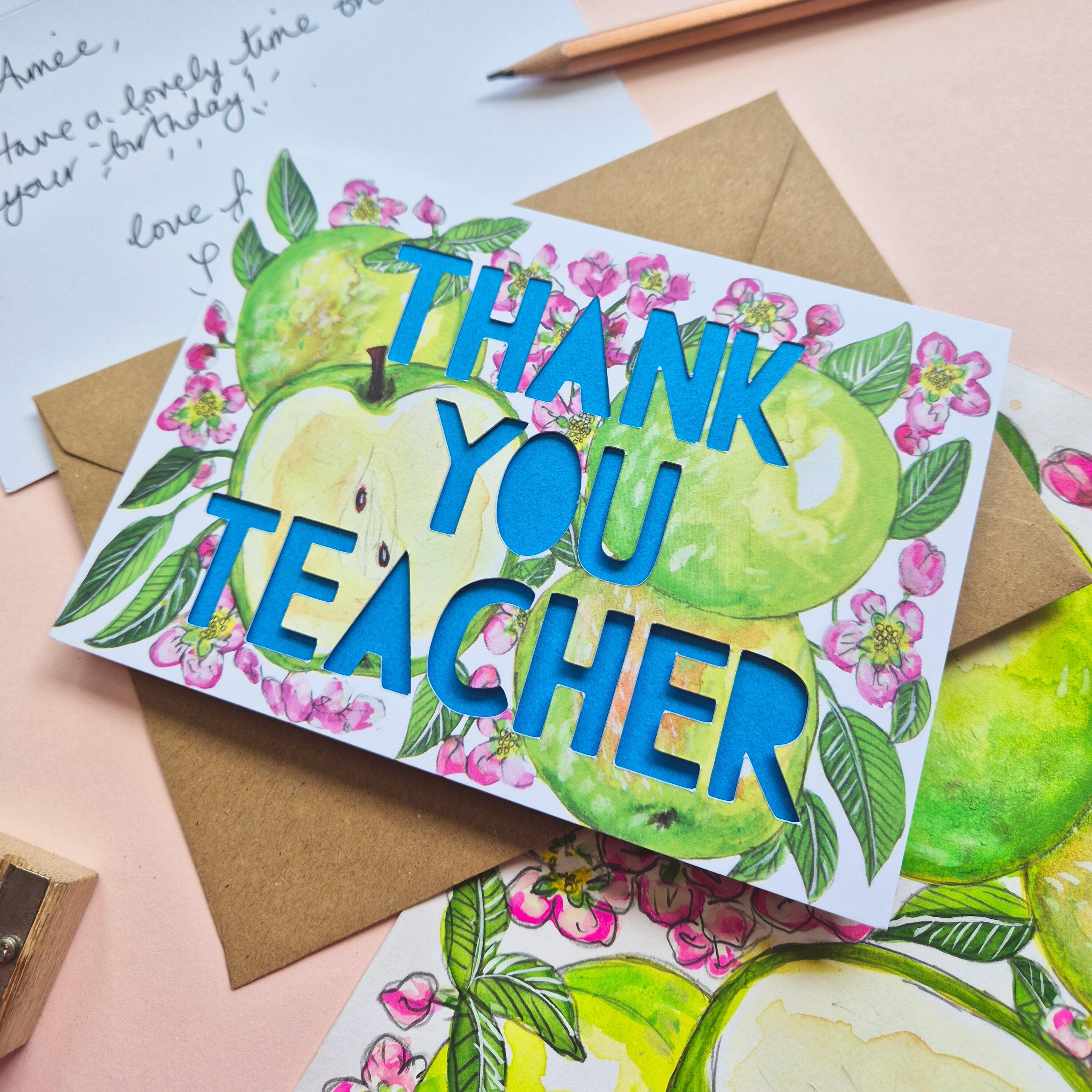 Floral and apple illustration with Thank You teacher paper cut text and bright blue backing paper