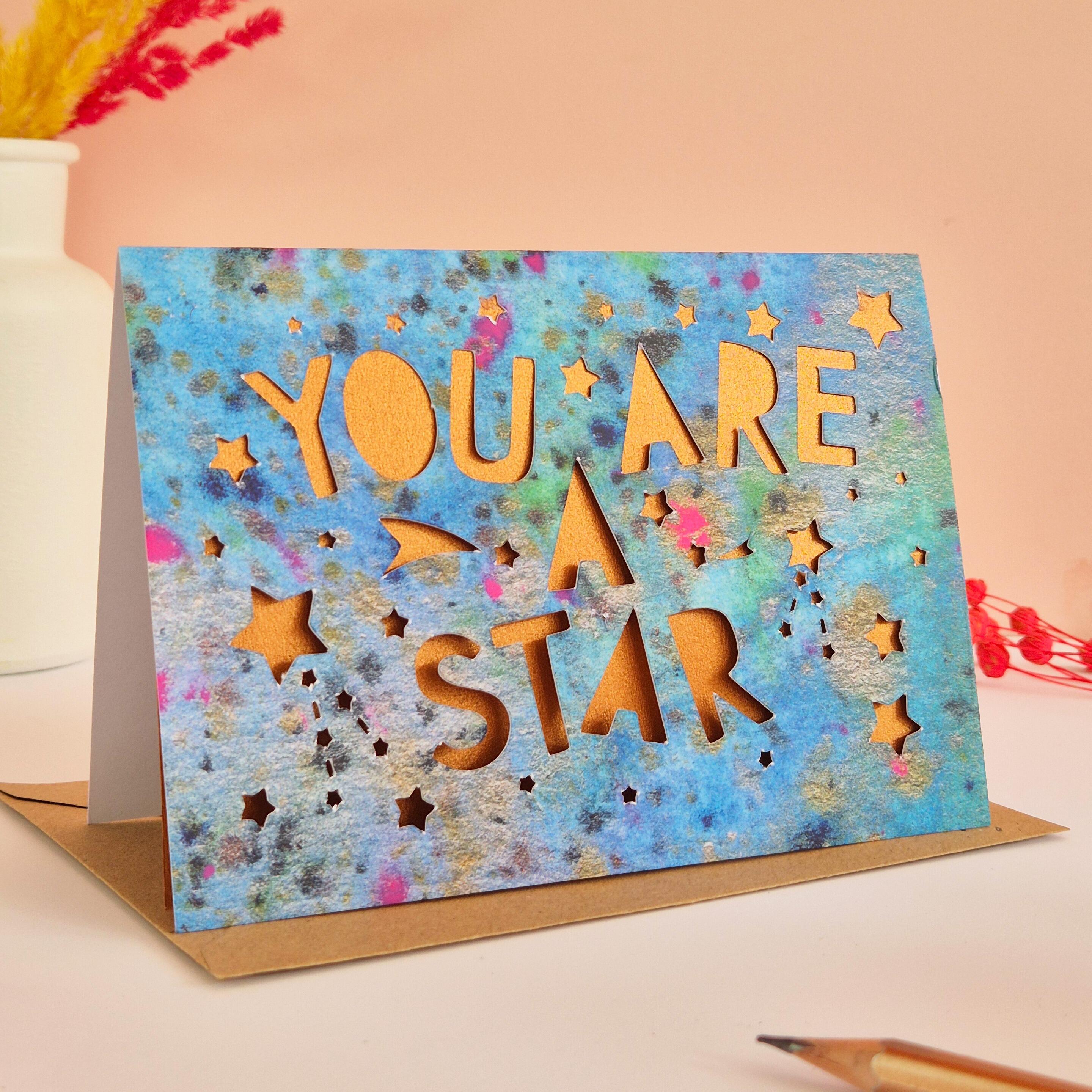 Celestial Thank You card with die cut 'You are a star' text and stars, backed with a shimmering bronze liner