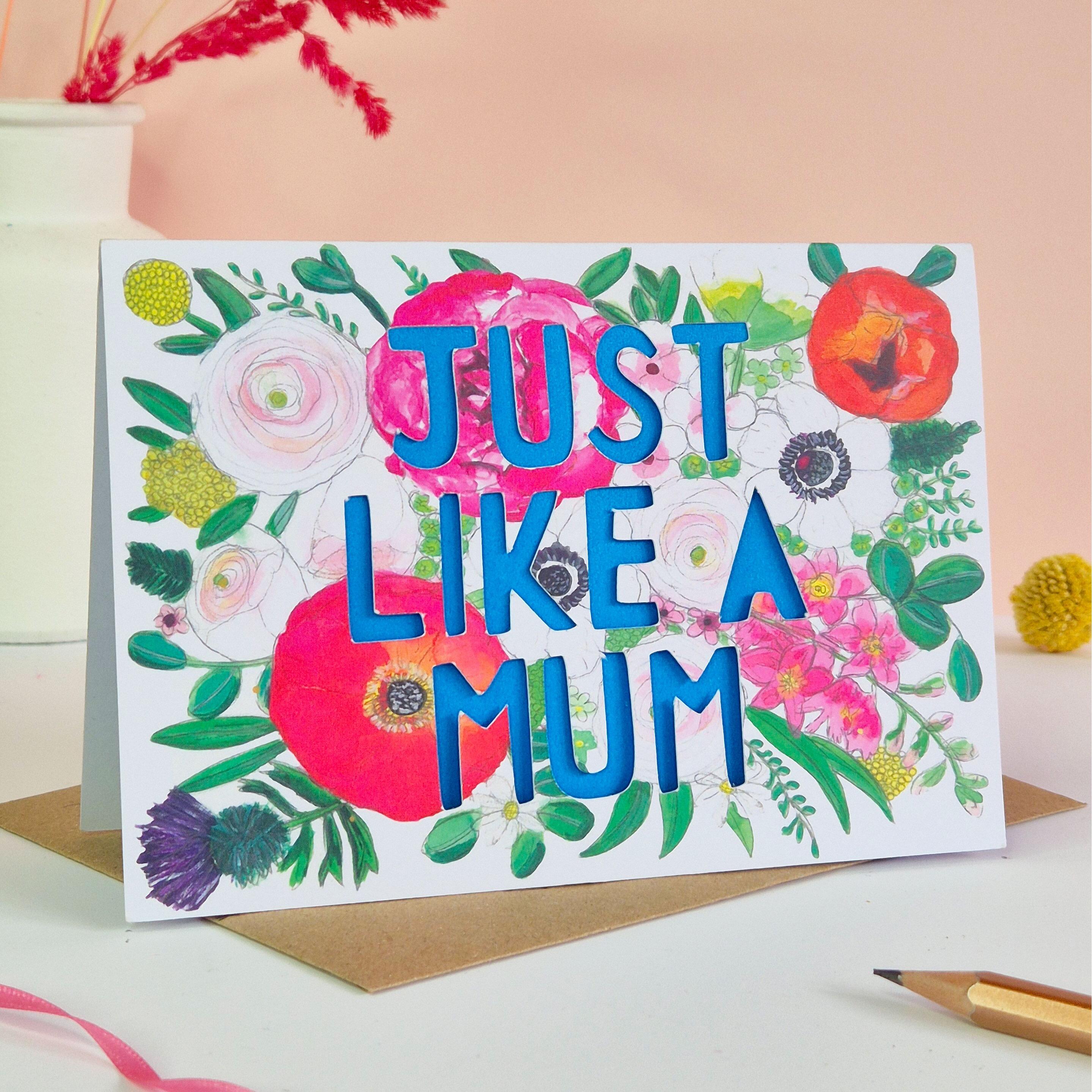 Just like a mum card with paper cut text in blue