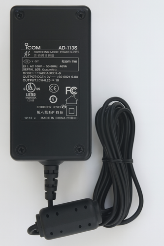 Icom AD-113S power supply with visible label, coiled cable, and ferrite bead on white background