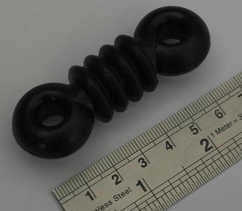 Black ribbed dog bone antenna insulator medium.