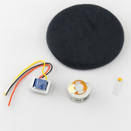 Electronic components including HC‑5.1 microphone capsule, transformer with wires, foam pad, and capacitor arranged on a light background.