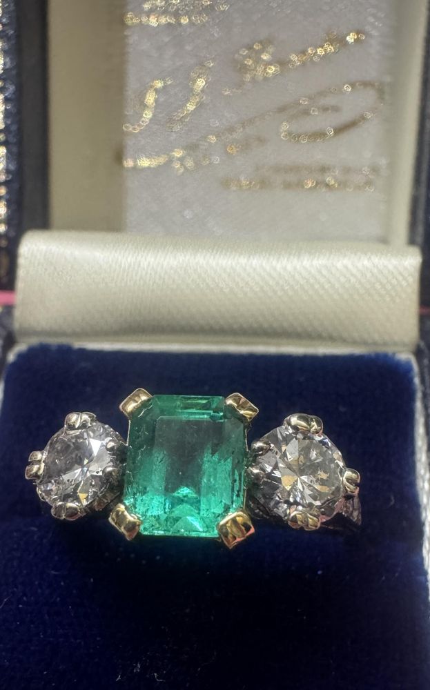 Classic emerald and diamond three stone ring