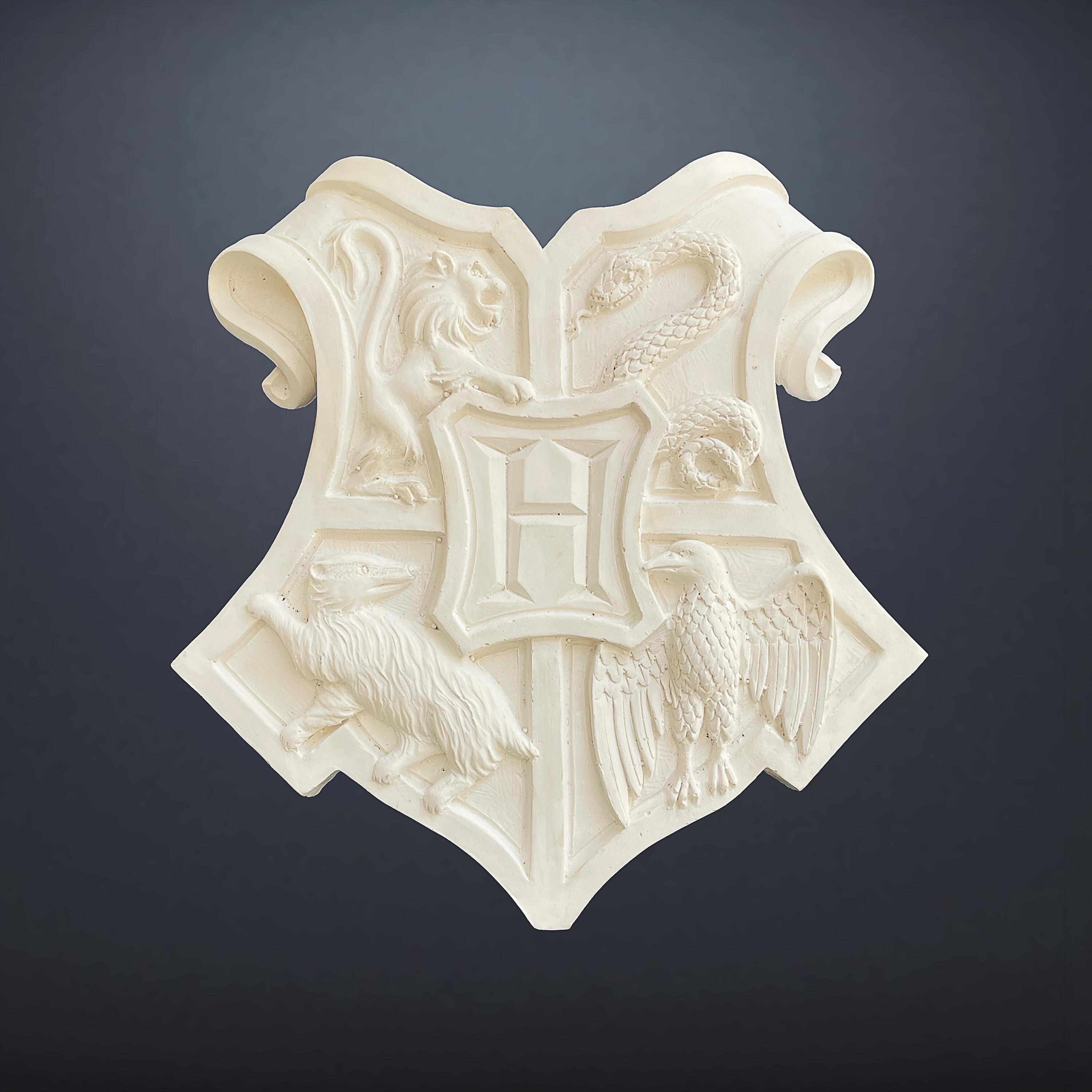 Original production-made Hogwarts Crest prop from Harry Potter and the Philosopher's / Sorcerer's Stone (2001), unpainted resin-moulded plaster coat of arms with Certificate of Authenticity.