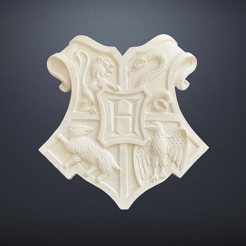 Original production-made Hogwarts Crest prop from Harry Potter and the Philosopher's / Sorcerer's Stone (2001), unpainted resin-moulded plaster coat of arms with Certificate of Authenticity.