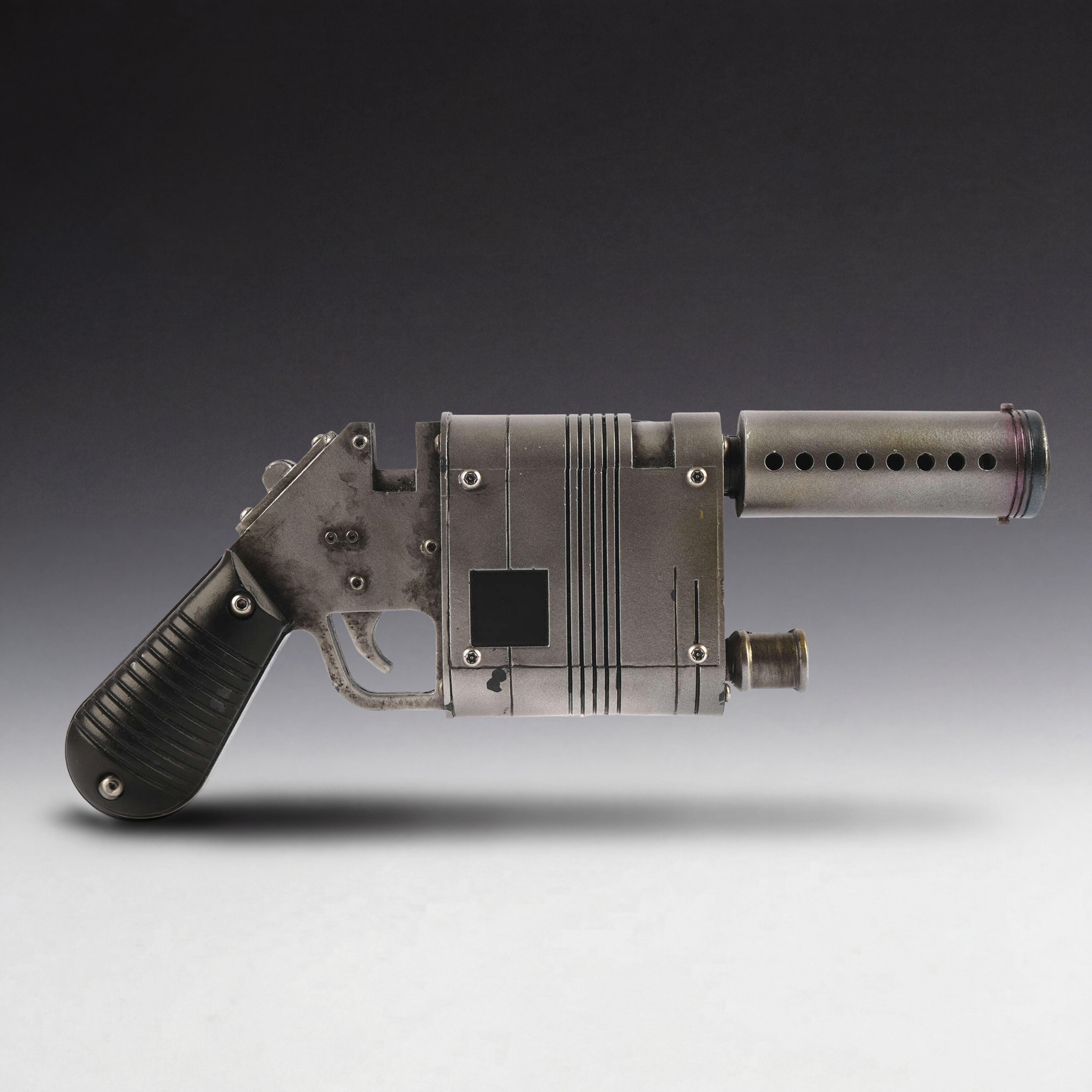 Production-made Rey NN-14 blaster from Star Wars: The Force Awakens with iridescent finish and simulated heat-damage muzzle.