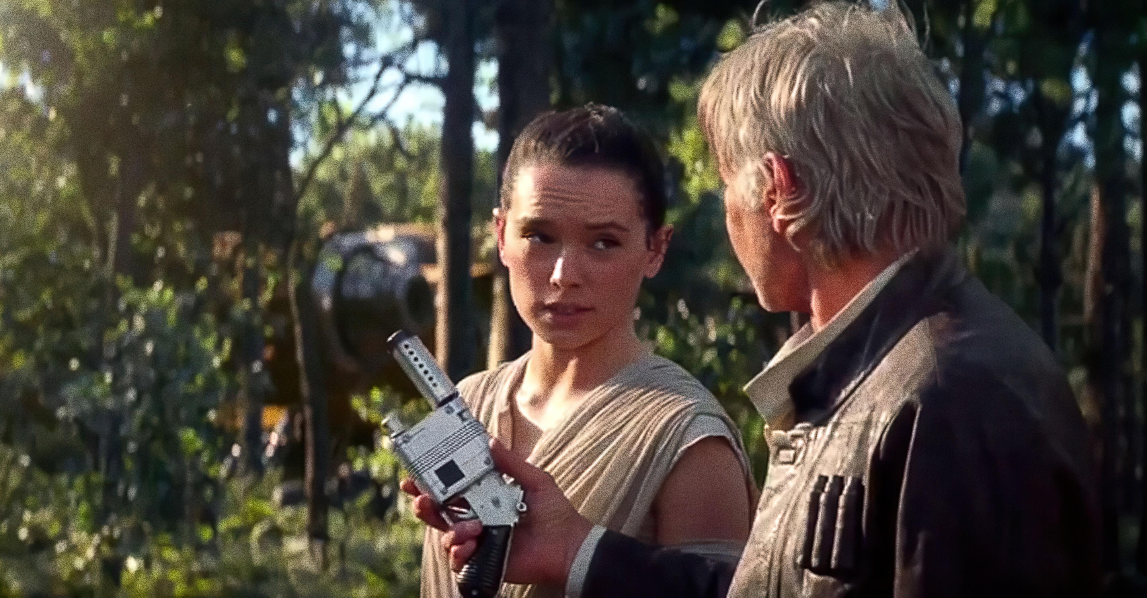 Han Solo (Harrison Ford) giving Rey (Daisy Ridley) a NN-14 blaster in Star Wars: The Force Awakens