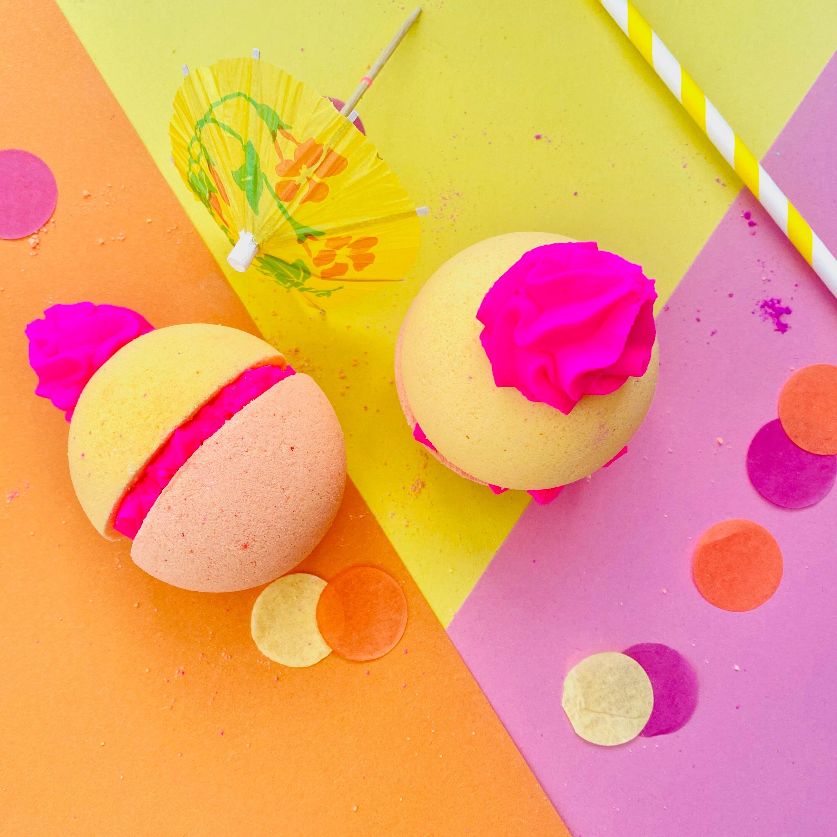 Candy Crush bath bomb with yellow and orange base and piped pink frosting