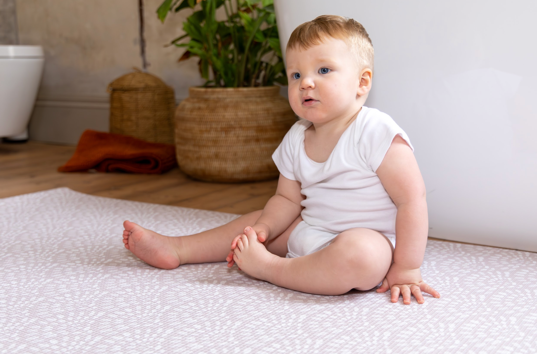 Baby playing on Large Scandi Pink playmat – soft 1.5 cm cushioned reversible foam design by Little Fae