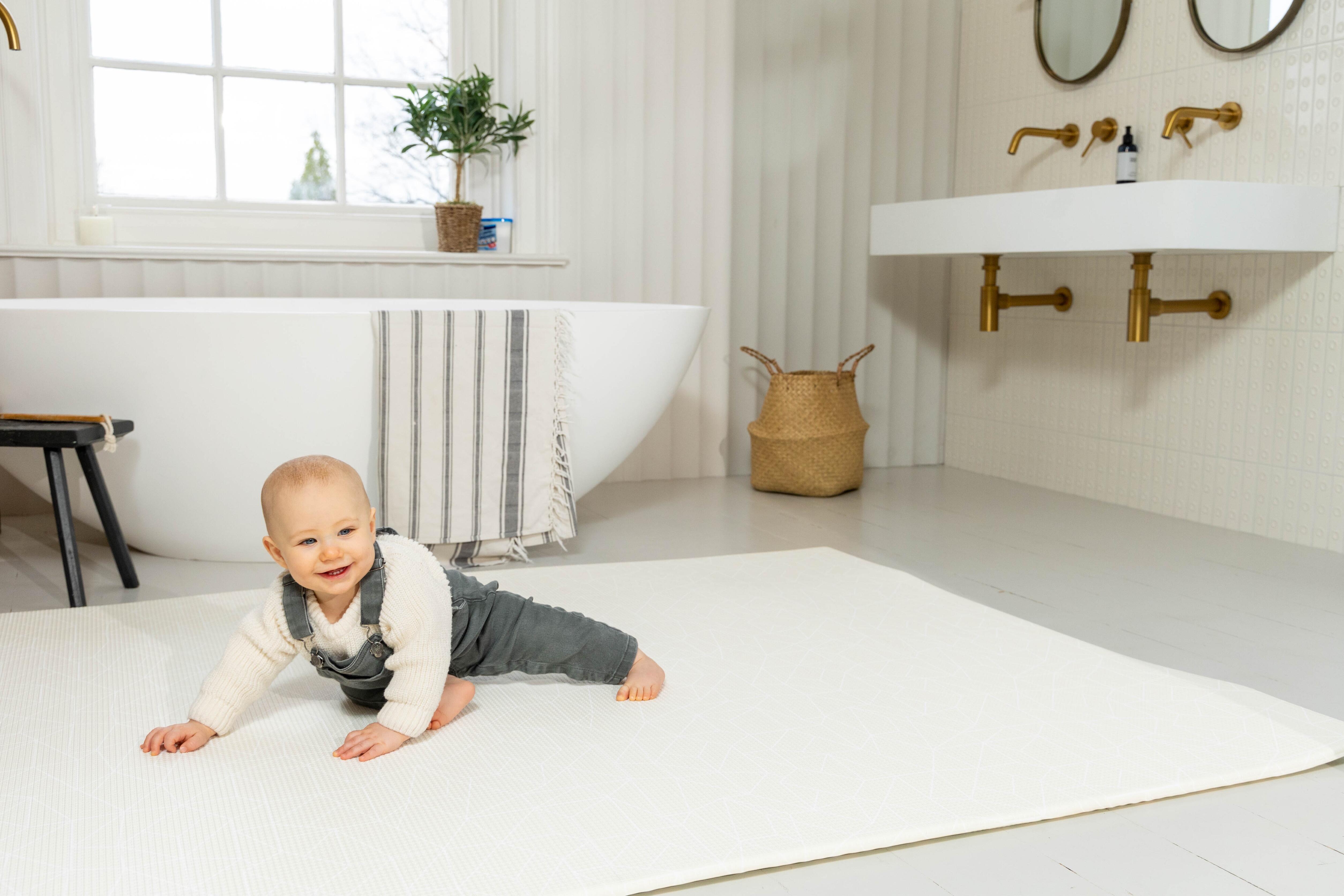 Warm neutral Cornish Cream Nordic Explorer Playmat laid out on wooden flooring