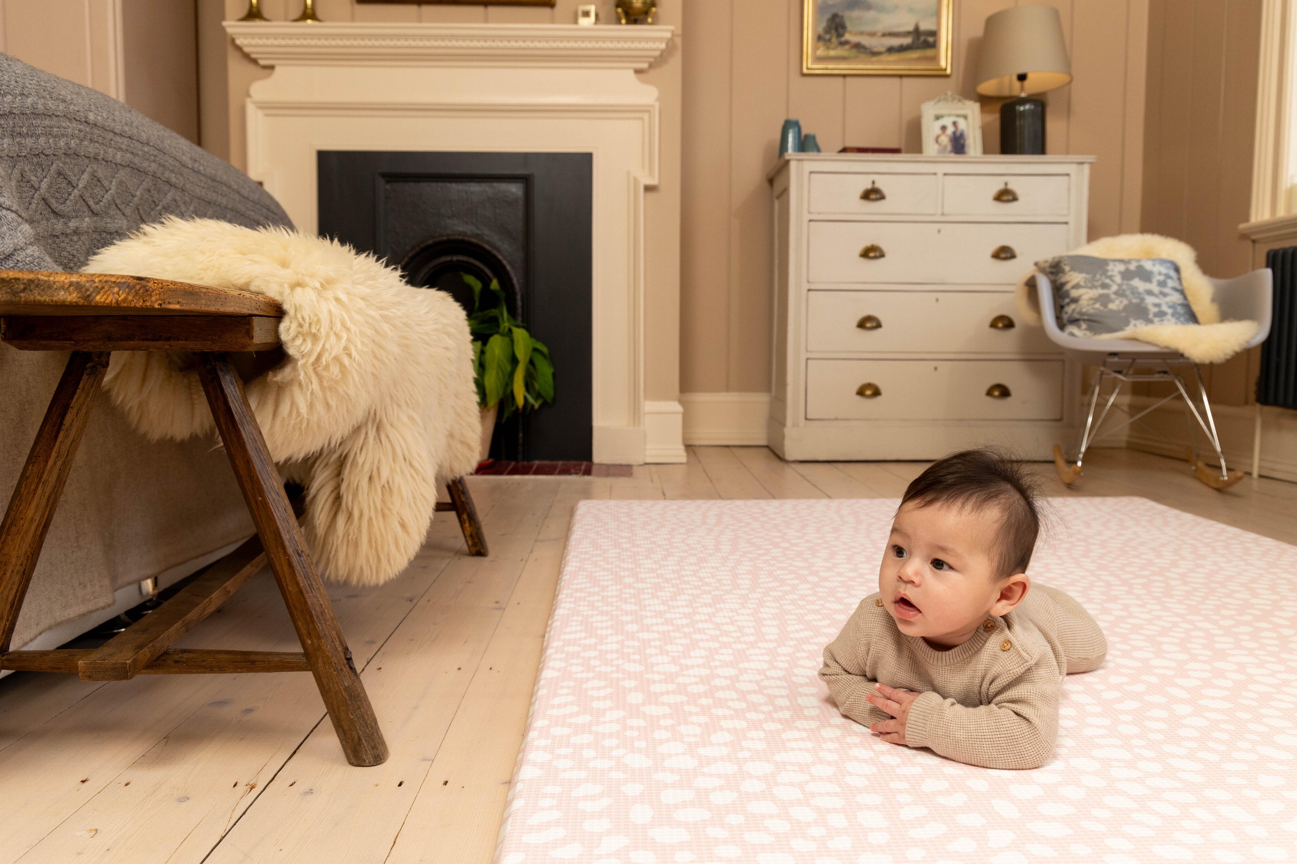 Lifestyle image of Blush Pink baby playmat – elegant reversible foam design blending with modern home décor