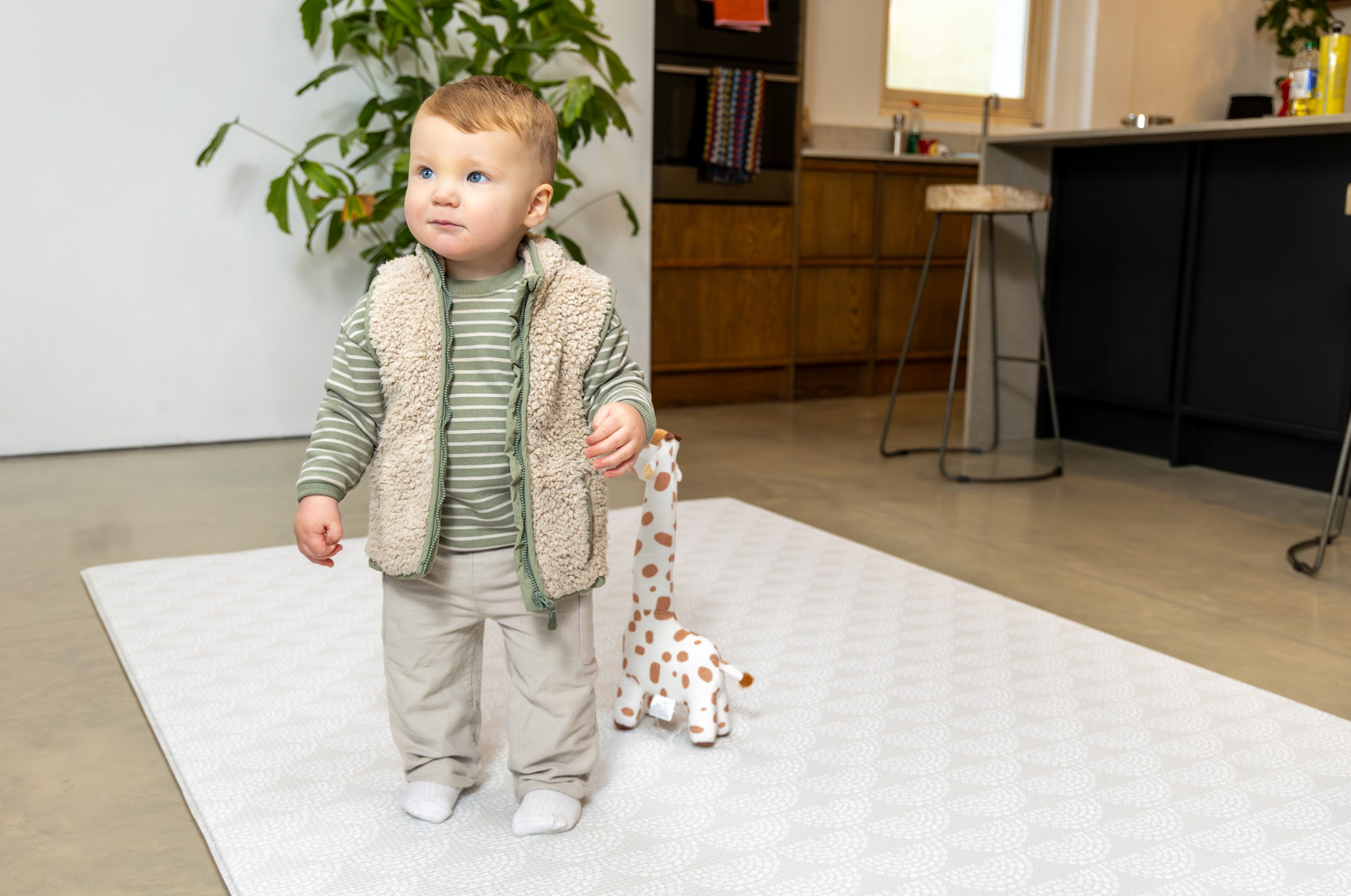 Baby standing on playmat