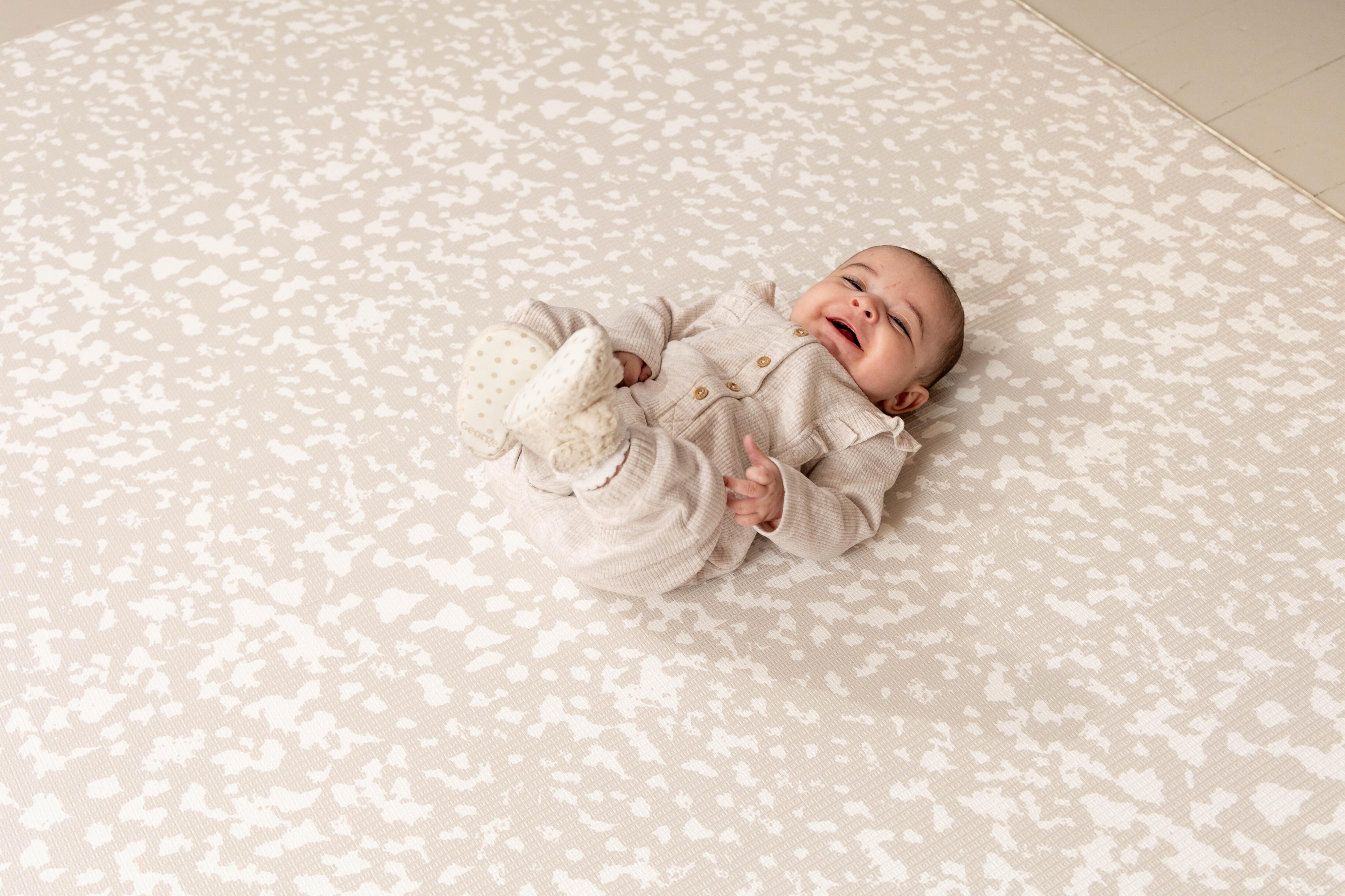 Neutral Luxury Greige Speckled Kisses Playmat shown in natural home lighting