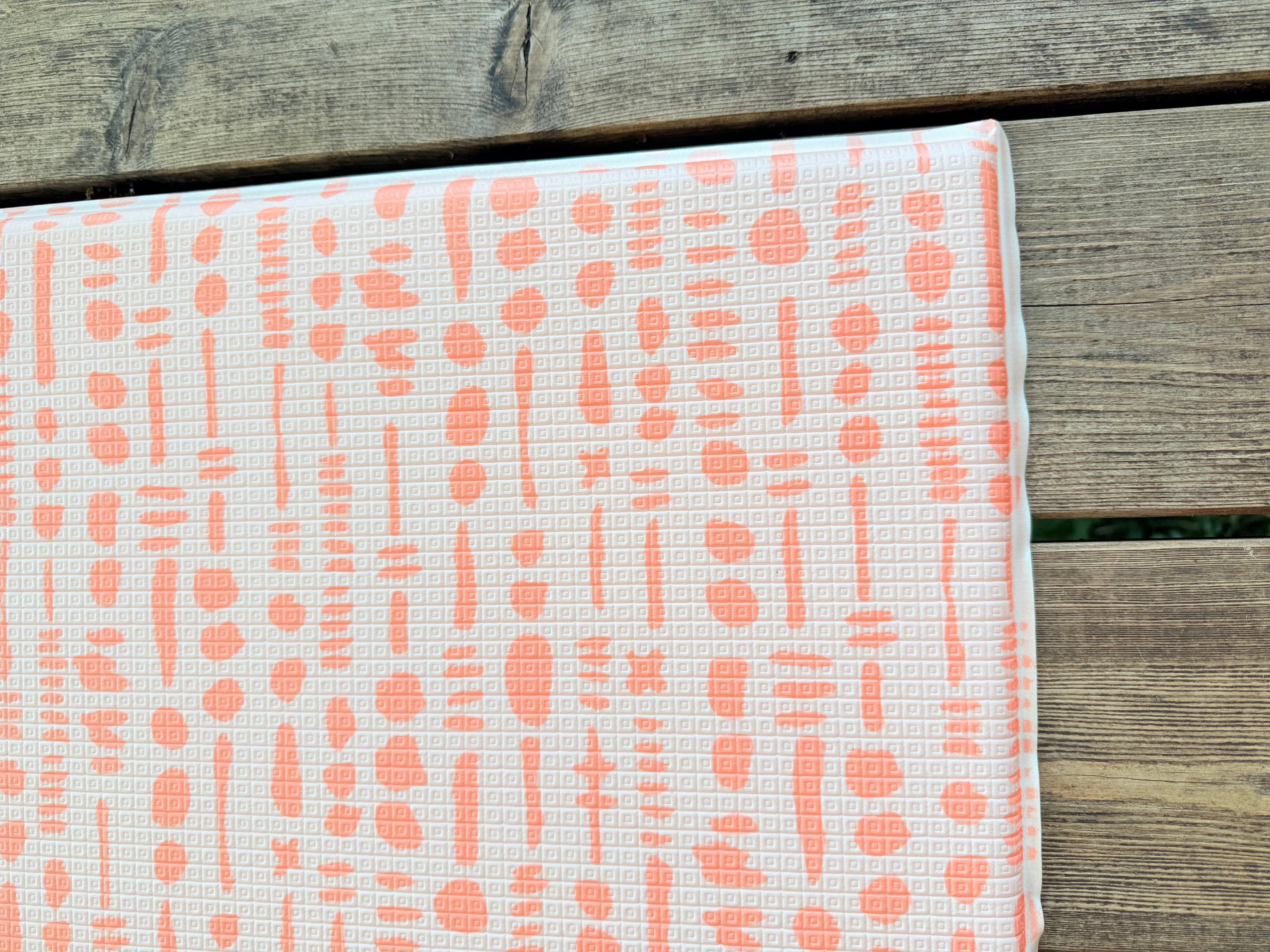 Close-up of Coral textured surface on Saga reversible playmat β wipe-clean non-toxic finish